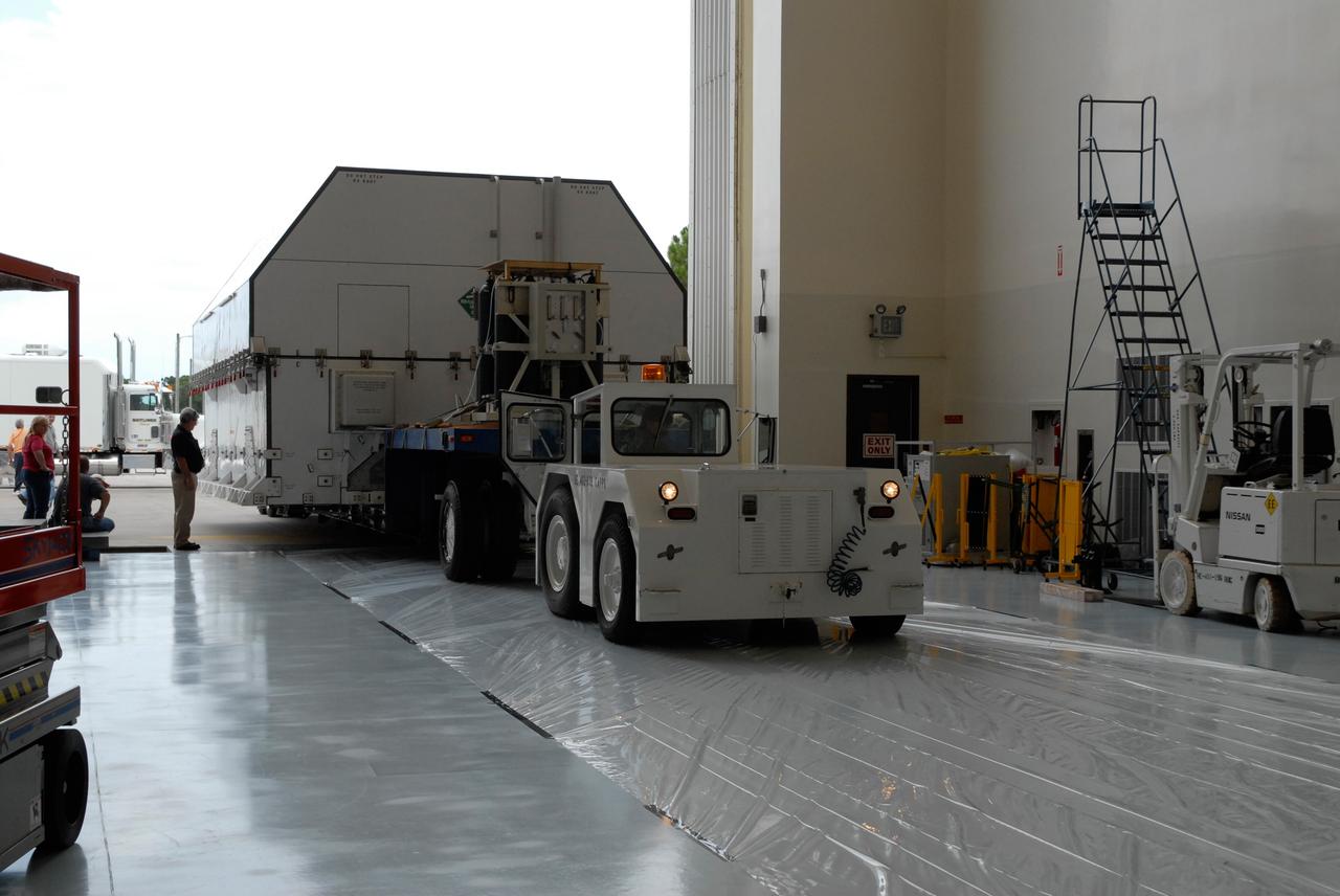 CAPE CANAVERAL, Fla. –   A second shipping container of major flight hardware for space shuttle Atlantis' STS-125 mission to NASA's Hubble Space Telescope is moved into the airlock at the Payload Hazardous Servicing Facility at NASA's Kennedy Space Center.  The container holds the Super Lightweight Interchangeable Carrier, or SLIC, and the Orbital Replacement Unit Carrier, or ORUC.  In the facility, preparations will begin for its targeted October launch.  The payload carriers will be prepared for the integration of telescope science instruments, both internal and external replacement components, as well as the flight support equipment to be used by the astronauts during the servicing mission.  The three payload carriers or pallets are the Flight Support System, the SLIC and the ORUC.  At the end of July, a fourth and final carrier, the Multi-Use Lightweight Equipment carrier will join the others in the Payload Hazardous Servicing Facility where the Hubble payload is being prepared for launch. Photo credit: NASA/Amanda Diller
