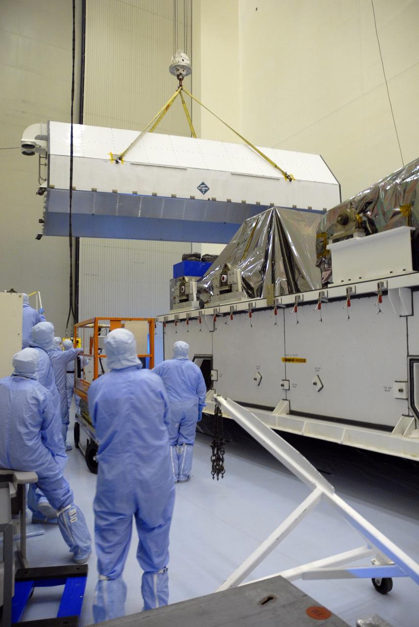 CAPE CANAVERAL, Fla. – In the Payload Hazardous Servicing Facility at NASA's Kennedy Space Center, an overhead crane removes the cover of the shipping container containing the hardware for space shuttle Atlantis' STS-125 mission to NASA's Hubble Space Telescope.  The container holds the Super Lightweight Interchangeable Carrier, or SLIC, and the Orbital Replacement Unit Carrier, or ORUC. Another payload carrier, the Flight Support System, has already been delivered,  and the Multi-Use Lightweight Equipment carrier will be delivered in late July. The carriers will be prepared for the integration of telescope science instruments, both internal and external replacement components, as well as the flight support equipment to be used by the astronauts during the Hubble servicing mission, targeted for launch Oct. 8.  Photo credit: NASA/Jack Pfaller