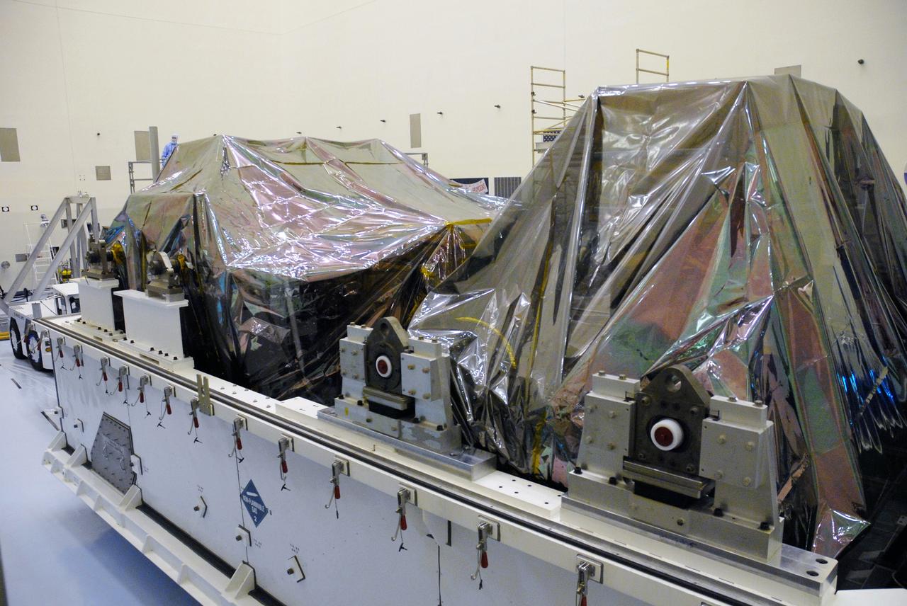 CAPE CANAVERAL, Fla. –   In the Payload Hazardous Servicing Facility at NASA's Kennedy Space Center, the transporter holds the container with the second shipment of hardware space shuttle Atlantis' STS-125 mission to NASA's Hubble Space Telescope. The container holds the Super Lightweight Interchangeable Carrier, or SLIC, and the Orbital Replacement Unit Carrier, or ORUC. Another payload carrier, the Flight Support System, has already been delivered,  and the Multi-Use Lightweight Equipment carrier will be delivered in late July. The carriers will be prepared for the integration of telescope science instruments, both internal and external replacement components, as well as the flight support equipment to be used by the astronauts during the Hubble servicing mission, targeted for launch Oct. 8.  Photo credit: NASA/Jack Pfaller