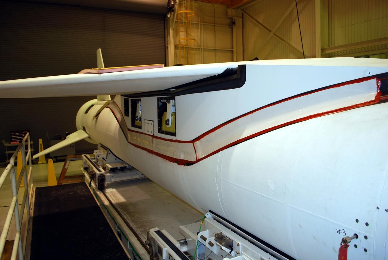 VANDENBERG AIR FORCE BASE, Calif. -- Avionics shelf flatness and fillet gap measurements are conducted on the wing of a Pegasus rocket in Building 1555 at Vandenberg AFB. The testing was performed by workers from Advanced Digital Measuring Works using an API laser tracker. The Pegasus will launch NASA's Interstellar Boundary Explorer Mission, or IBEX, satellite from Kwajalein Island in the Marshall Islands, South Pacific. IBEX will make the first map of the boundary between the solar system and interstellar space. IBEX is the first mission designed to detect the edge of the solar system. As the solar wind from the sun flows out beyond Pluto, it collides with the material between the stars, forming a shock front. IBEX contains two neutral atom imagers designed to detect particles from the termination shock at the boundary between the solar system and interstellar space. IBEX also will study galactic cosmic rays, energetic particles from beyond the solar system that pose a health and safety hazard for humans exploring beyond Earth orbit. IBEX will make these observations from a highly elliptical orbit that takes it beyond the interference of the Earth's magnetosphere. IBEX is targeted for launch in October 2008. Photo credit: NASA/Randy Beaudoin