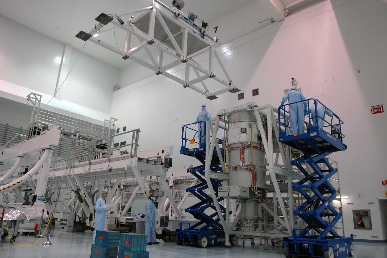 CAPE CANAVERAL, Fla. – In the Space Station Processing Facility at NASA's Kennedy Space Center, workers prepare to install the final solar array wing for the International Space Station onto the S6 truss element. Scheduled to launch on the STS-119 mission, space shuttle Discovery will carry the S6 truss segment to complete the 361-foot-long backbone of the International Space Station. The truss includes the fourth pair of solar array wings and electronics that convert sunlight to power for the orbiting laboratory. Launch is targeted for Feb. 12, 2009.  Photo credit: NASA/Troy Cryder