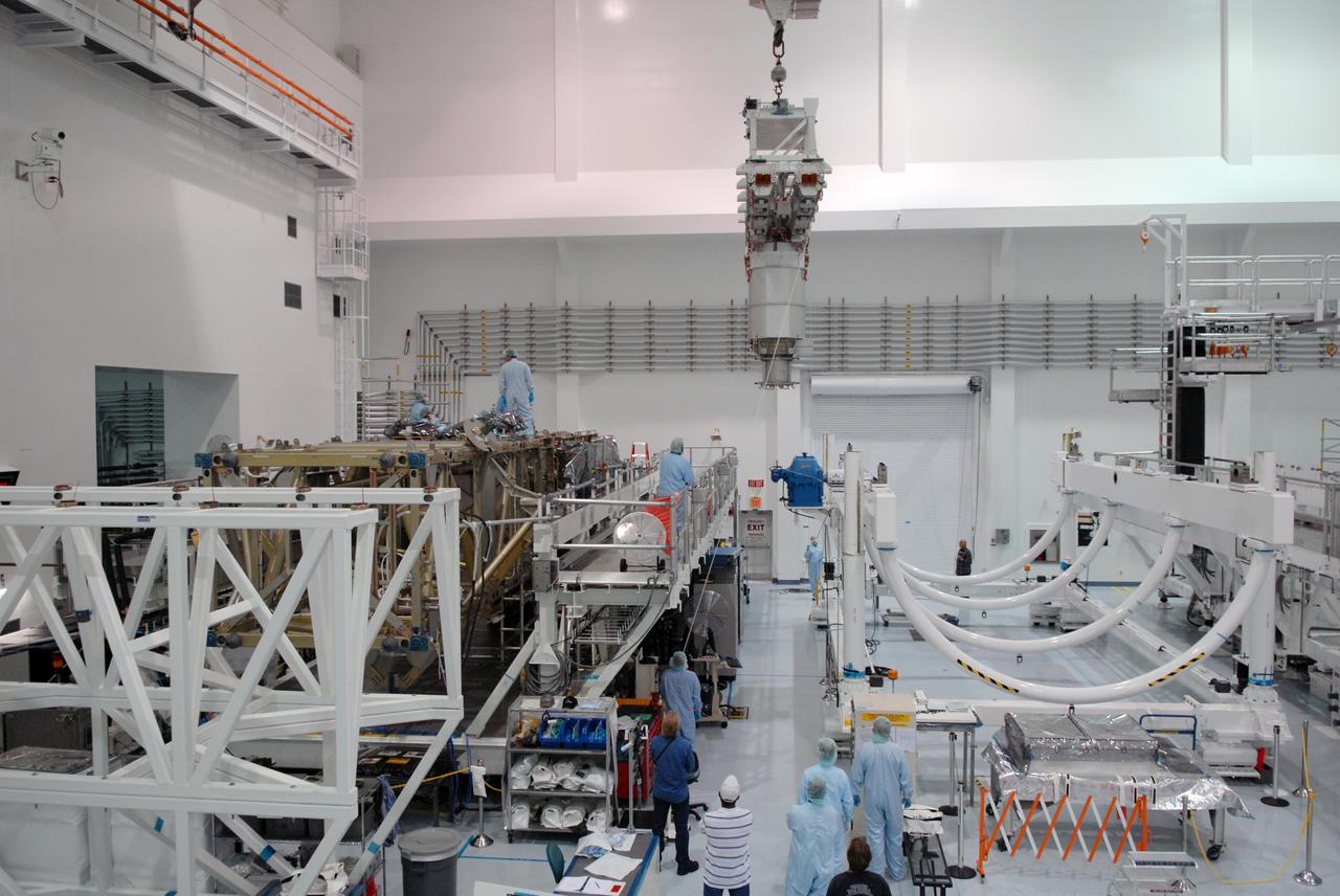 CAPE CANAVERAL, Fla. – In the Space Station Processing Facility at NASA's Kennedy Space Center, workers move the final solar array wing for the International Space Station into position for installation on the S6 truss element. Scheduled to launch on the STS-119 mission, space shuttle Discovery will carry the S6 truss segment to complete the 361-foot-long backbone of the International Space Station. The truss includes the fourth pair of solar array wings and electronics that convert sunlight to power for the orbiting laboratory. Launch is targeted for Feb. 12, 2009. Photo credit: NASA/Troy Cryder