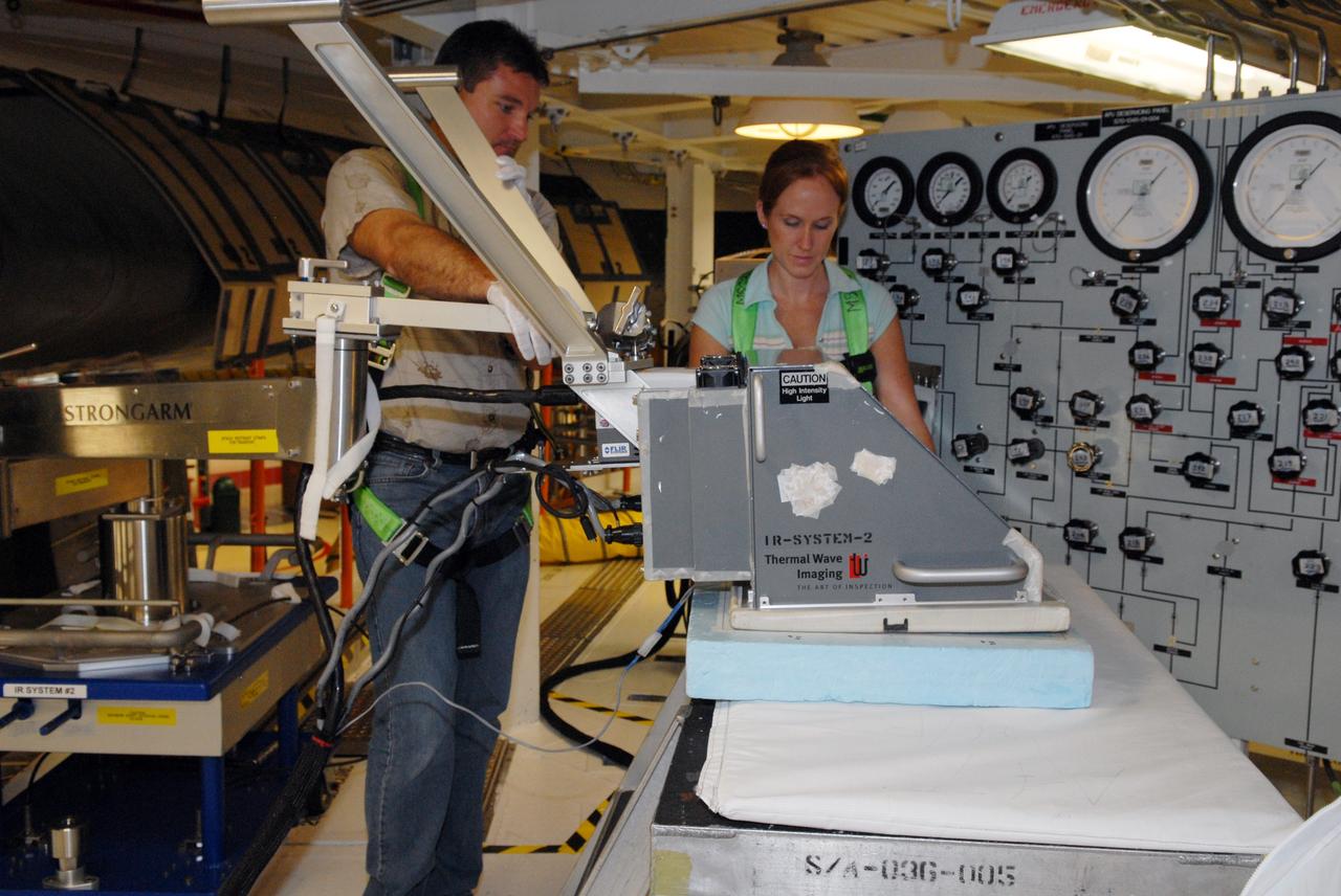 CAPE CANAVERAL, Fla. – Inside Orbiter Processing Facility 2 at NASA's Kennedy Space Center, United Space Alliance technicians inspect a reinforced carbon-carbon panel on Endeavour's wing leading edge using thermography to detect structural abnormalities. Endeavour will deliver a multi-purpose logistics module to the International Space Station on its STS-126 mission. Launch is targeted for Nov. 10. Photo credit: NASA/Amanda Diller