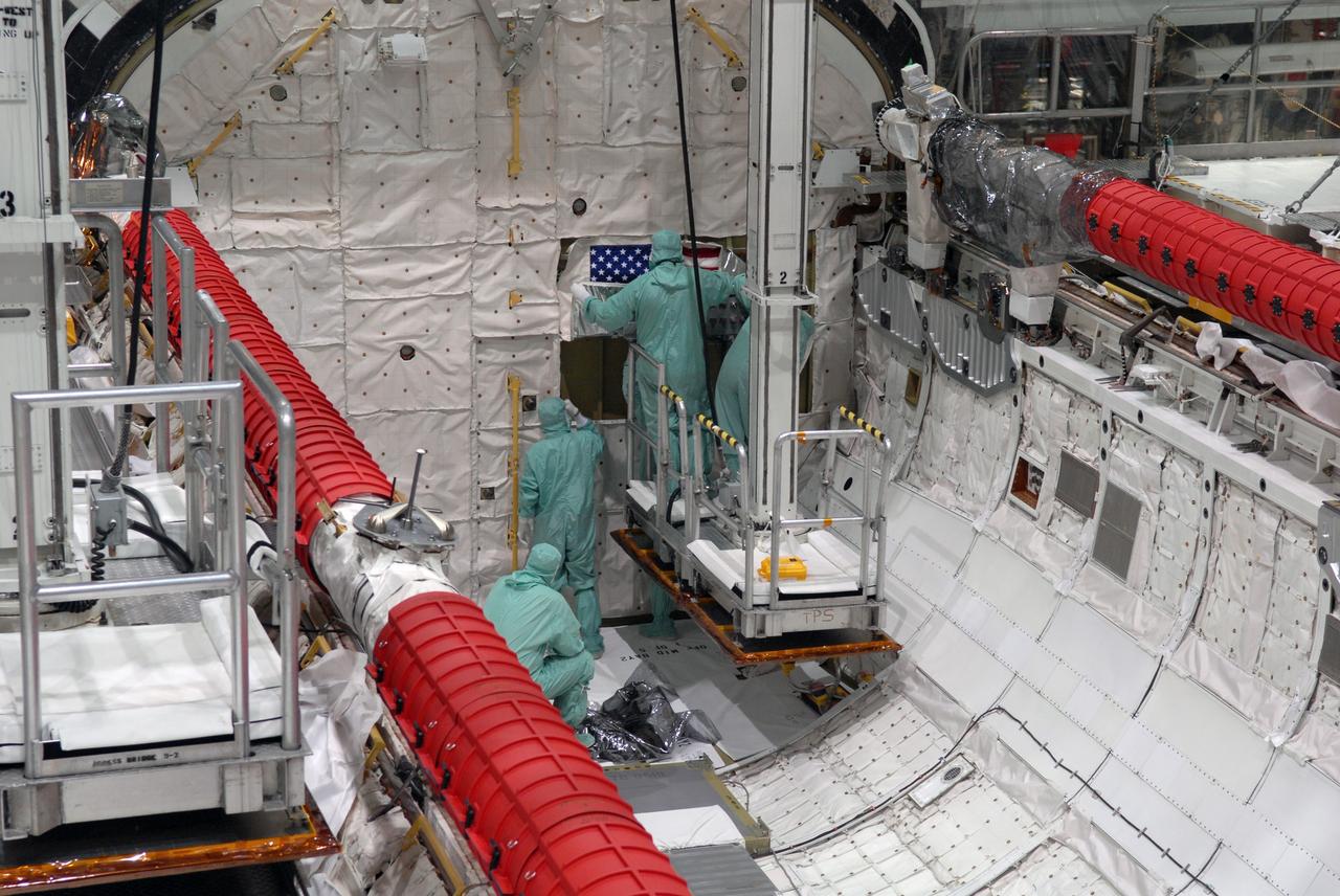 CAPE CANAVERAL, Fla. – Inside Orbiter Processing Facility 2 at NASA's Kennedy Space Center, United Space Alliance technicians secure the U.S. flag in space shuttle Endeavour's payload bay during processing.  Endeavour will deliver a multi-purpose logistics module to the International Space Station on its STS-126 mission. Launch is targeted for Nov. 10.  Photo credit: NASA/Amanda Diller