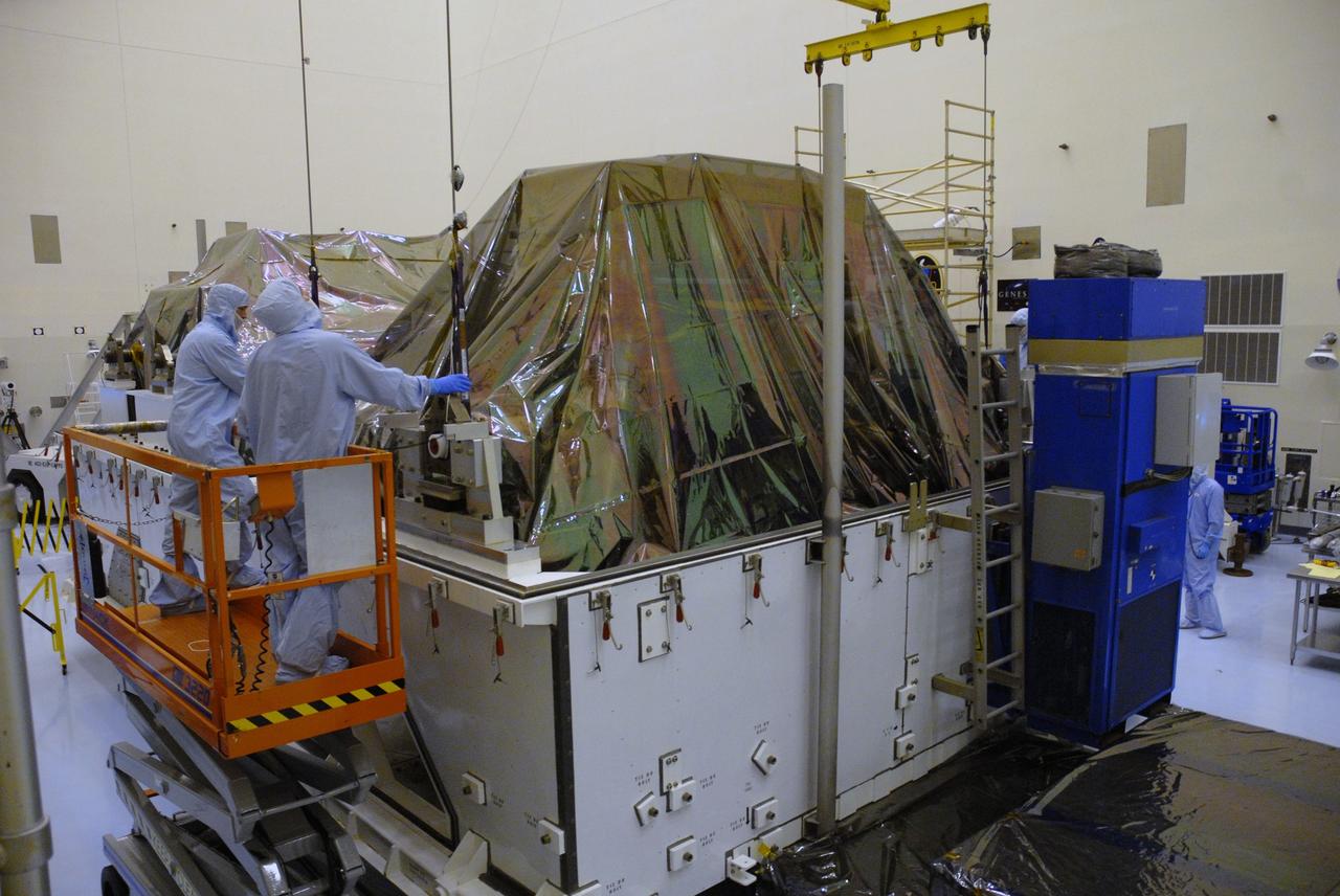 CAPE CANAVERAL, Fla. – In the high bay of the Payload Hazardous Servicing Facility at NASA's Kennedy Space Center, workers from NASA's Goddard Space Flight Center prepare to lift the Flight Support System for the Hubble Space Telescope from its transportation canister. The Flight Support System, or FSS, is one of four carriers supporting hardware for space shuttle Atlantis' STS-125 mission to service the telescope. The Super Lightweight Interchangeable Carrier, or SLIC, and the Orbital Replacement Unit Carrier, or ORUC, have also arrived at Kennedy. The Multi-Use Lightweight Equipment carrier will be delivered in late July. The carriers will be prepared for the integration of telescope science instruments, both internal and external replacement components, as well as the flight support equipment to be used by the astronauts during the Hubble servicing mission, targeted for launch Oct. 8. Photo credit: NASA/Jack Pfaller