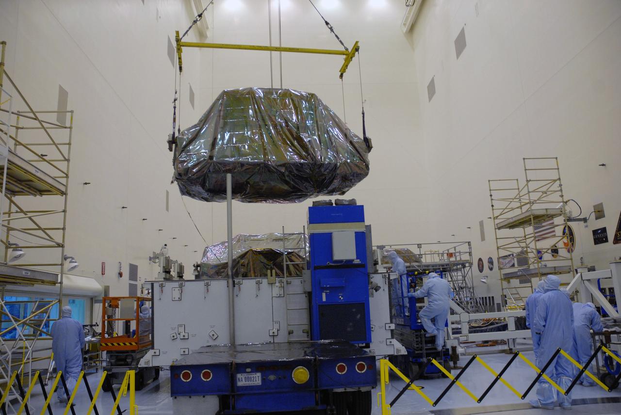 CAPE CANAVERAL, Fla. – In the high bay of the Payload Hazardous Servicing Facility at NASA's Kennedy Space Center, the Flight Support System for the Hubble Space Telescope is lifted from its transportation canister by workers from NASA's Goddard Space Flight Center. The Flight Support System, or FSS, is one of four carriers supporting hardware for space shuttle Atlantis' STS-125 mission to service the telescope. The Super Lightweight Interchangeable Carrier, or SLIC, and the Orbital Replacement Unit Carrier, or ORUC, have also arrived at Kennedy. The Multi-Use Lightweight Equipment carrier will be delivered in late July. The carriers will be prepared for the integration of telescope science instruments, both internal and external replacement components, as well as the flight support equipment to be used by the astronauts during the Hubble servicing mission, targeted for launch Oct. 8. Photo credit: NASA/Jack Pfaller