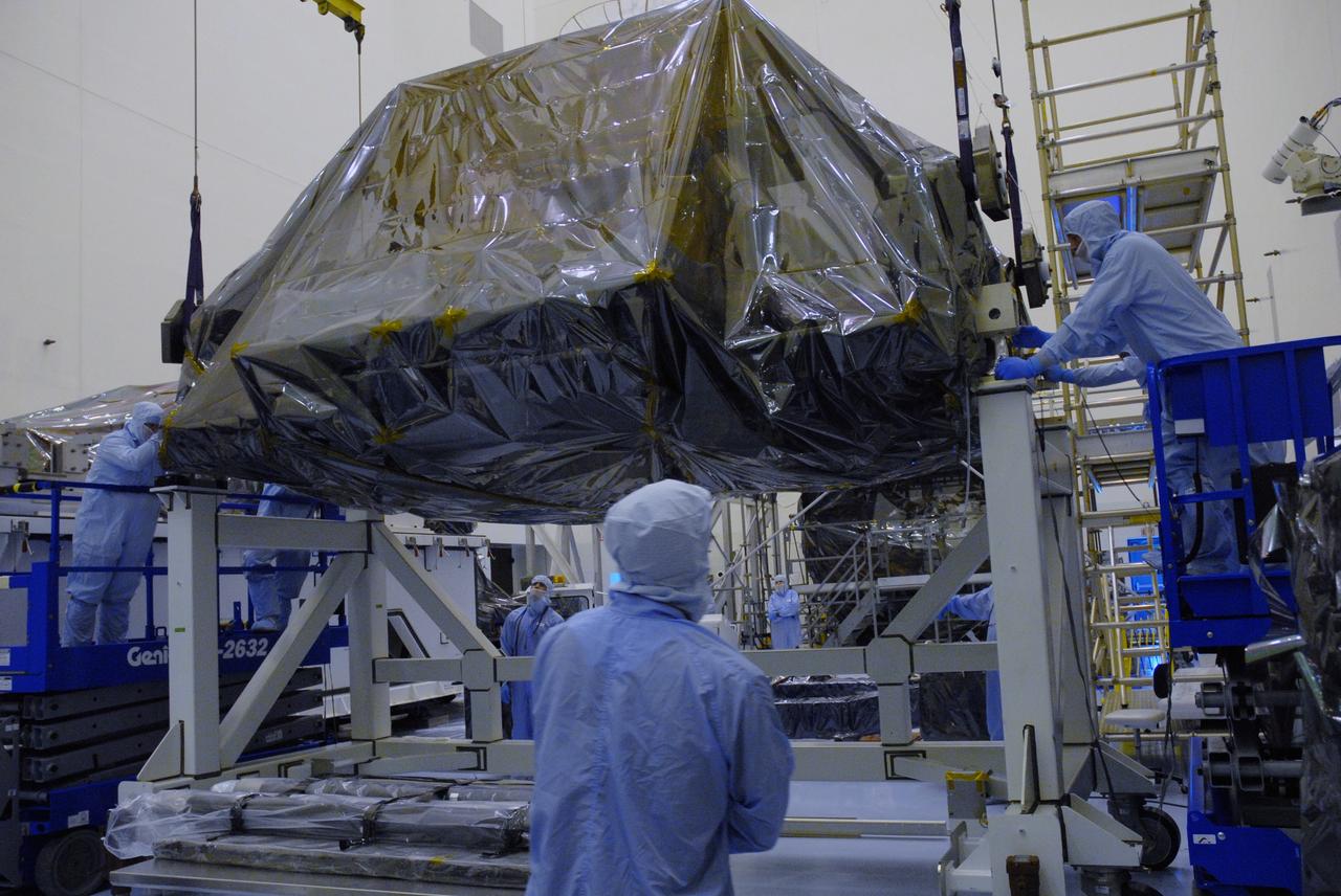 CAPE CANAVERAL, Fla. – In the high bay of the Payload Hazardous Servicing Facility at NASA's Kennedy Space Center, the Flight Support System for the Hubble Space Telescope is lowered onto a work platform by workers from NASA's Goddard Space Flight Center. The Flight Support System, or FSS, is one of four carriers supporting hardware for space shuttle Atlantis' STS-125 mission to service the telescope. The Super Lightweight Interchangeable Carrier, or SLIC, and the Orbital Replacement Unit Carrier, or ORUC, have also arrived at Kennedy. The Multi-Use Lightweight Equipment carrier will be delivered in late July. The carriers will be prepared for the integration of telescope science instruments, both internal and external replacement components, as well as the flight support equipment to be used by the astronauts during the Hubble servicing mission, targeted for launch Oct. 8. Photo credit: NASA/Jack Pfaller