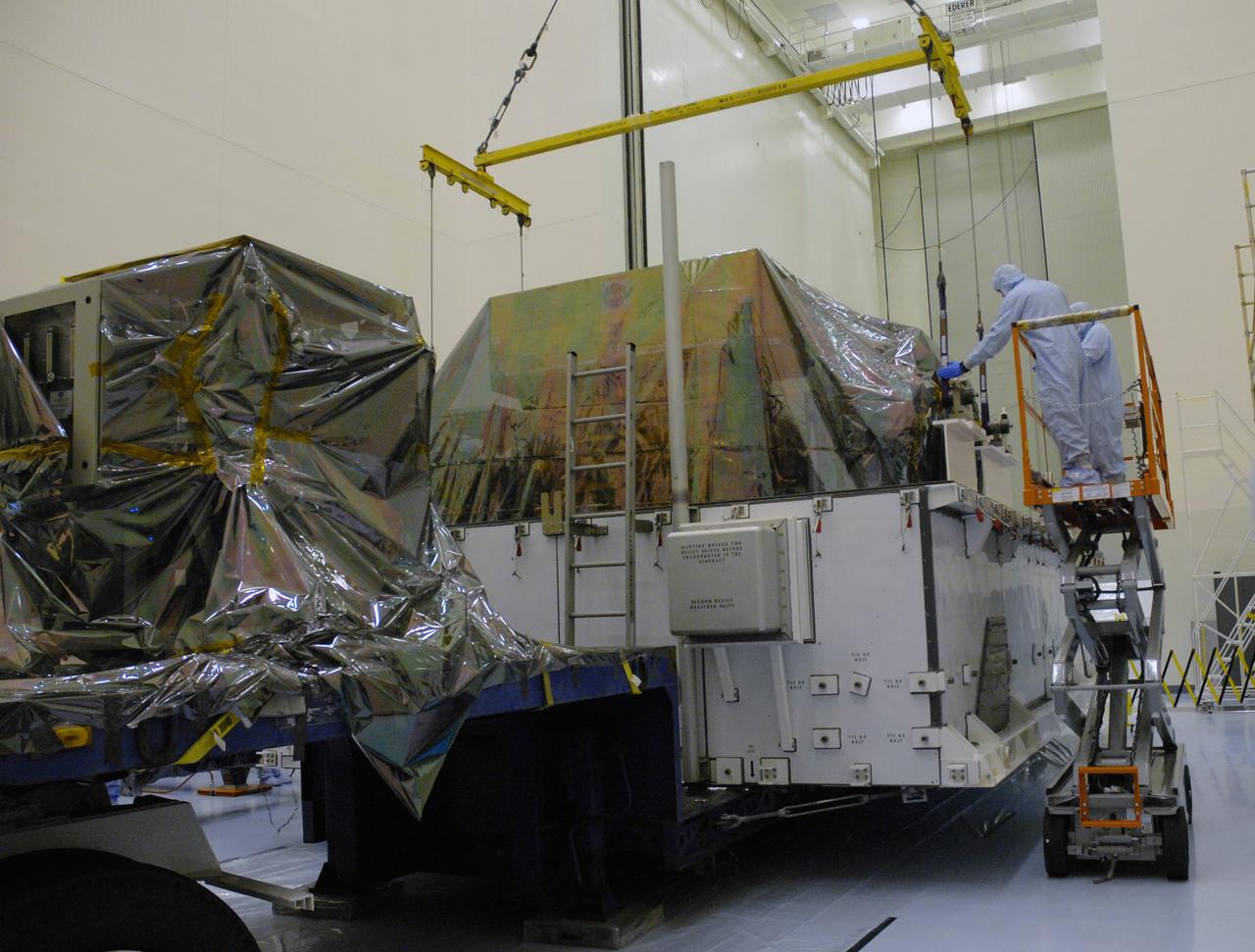 CAPE CANAVERAL, Fla. – In the high bay of the Payload Hazardous Servicing Facility at NASA's Kennedy Space Center, the Flight Support System for the Hubble Space Telescope is positioned onto a work platform by workers from NASA's Goddard Space Flight Center. The Flight Support System, or FSS, is one of four carriers supporting hardware for space shuttle Atlantis' STS-125 mission to service the telescope. The Super Lightweight Interchangeable Carrier, or SLIC, and the Orbital Replacement Unit Carrier, or ORUC, have also arrived at Kennedy. The Multi-Use Lightweight Equipment carrier will be delivered in late July. The carriers will be prepared for the integration of telescope science instruments, both internal and external replacement components, as well as the flight support equipment to be used by the astronauts during the Hubble servicing mission, targeted for launch Oct. 8. Photo credit: NASA/Jack Pfaller