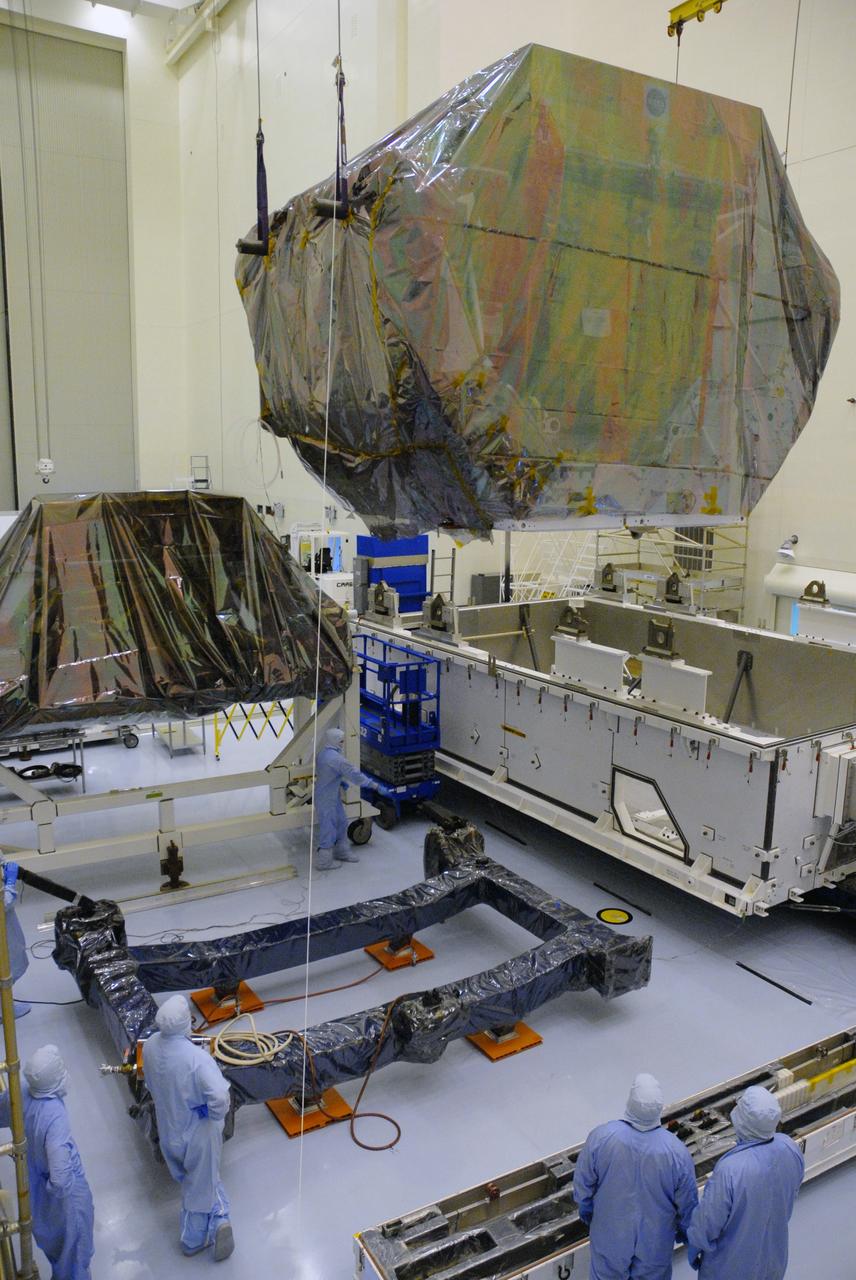 CAPE CANAVERAL, Fla. – In the high bay of the Payload Hazardous Servicing Facility at NASA's Kennedy Space Center, the Orbital Replacement Unit Carrier for the Hubble Space Telescope is lifted from its transportation canister by workers from NASA's Goddard Space Flight Center.  The Orbital Replacement Unit Carrier, or ORUC, is one of four carriers supporting hardware for space shuttle Atlantis' STS-125 mission to service the telescope. The Super Lightweight Interchangeable Carrier, or SLIC, and the Flight Support System, or FSS, at ground-level left, have also arrived at Kennedy. The Multi-Use Lightweight Equipment carrier will be delivered in late July. The carriers will be prepared for the integration of telescope science instruments, both internal and external replacement components, as well as the flight support equipment to be used by the astronauts during the Hubble servicing mission, targeted for launch Oct. 8. Photo credit: NASA/Jack Pfaller