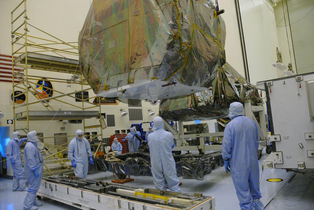 CAPE CANAVERAL, Fla. – In the high bay of the Payload Hazardous Servicing Facility at NASA's Kennedy Space Center, the Orbital Replacement Unit Carrier for the Hubble Space Telescope is lowered onto a work platform by workers from NASA's Goddard Space Flight Center.  The Orbital Replacement Unit Carrier, or ORUC, is one of four carriers supporting hardware for space shuttle Atlantis' STS-125 mission to service the telescope. The Super Lightweight Interchangeable Carrier, or SLIC, and the Flight Support System, or FSS, seen behind the ORUC, have also arrived at Kennedy. The Multi-Use Lightweight Equipment carrier will be delivered in late July. The carriers will be prepared for the integration of telescope science instruments, both internal and external replacement components, as well as the flight support equipment to be used by the astronauts during the Hubble servicing mission, targeted for launch Oct. 8. Photo credit: NASA/Jack Pfaller