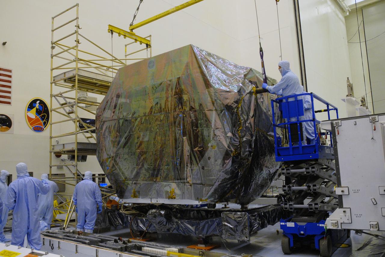 CAPE CANAVERAL, Fla. – In the high bay of the Payload Hazardous Servicing Facility at NASA's Kennedy Space Center, workers from NASA's Goddard Space Flight Center begin to remove the protective wrapping from the Orbital Replacement Unit Carrier for the Hubble Space Telescope. The Orbital Replacement Unit Carrier, or ORUC, is one of four carriers supporting hardware for space shuttle Atlantis' STS-125 mission to service the telescope. The Super Lightweight Interchangeable Carrier, or SLIC, and the Flight Support System, or FSS, have also arrived at Kennedy. The Multi-Use Lightweight Equipment carrier will be delivered in late July. The carriers will be prepared for the integration of telescope science instruments, both internal and external replacement components, as well as the flight support equipment to be used by the astronauts during the Hubble servicing mission, targeted for launch Oct. 8. Photo credit: NASA/Jack Pfaller