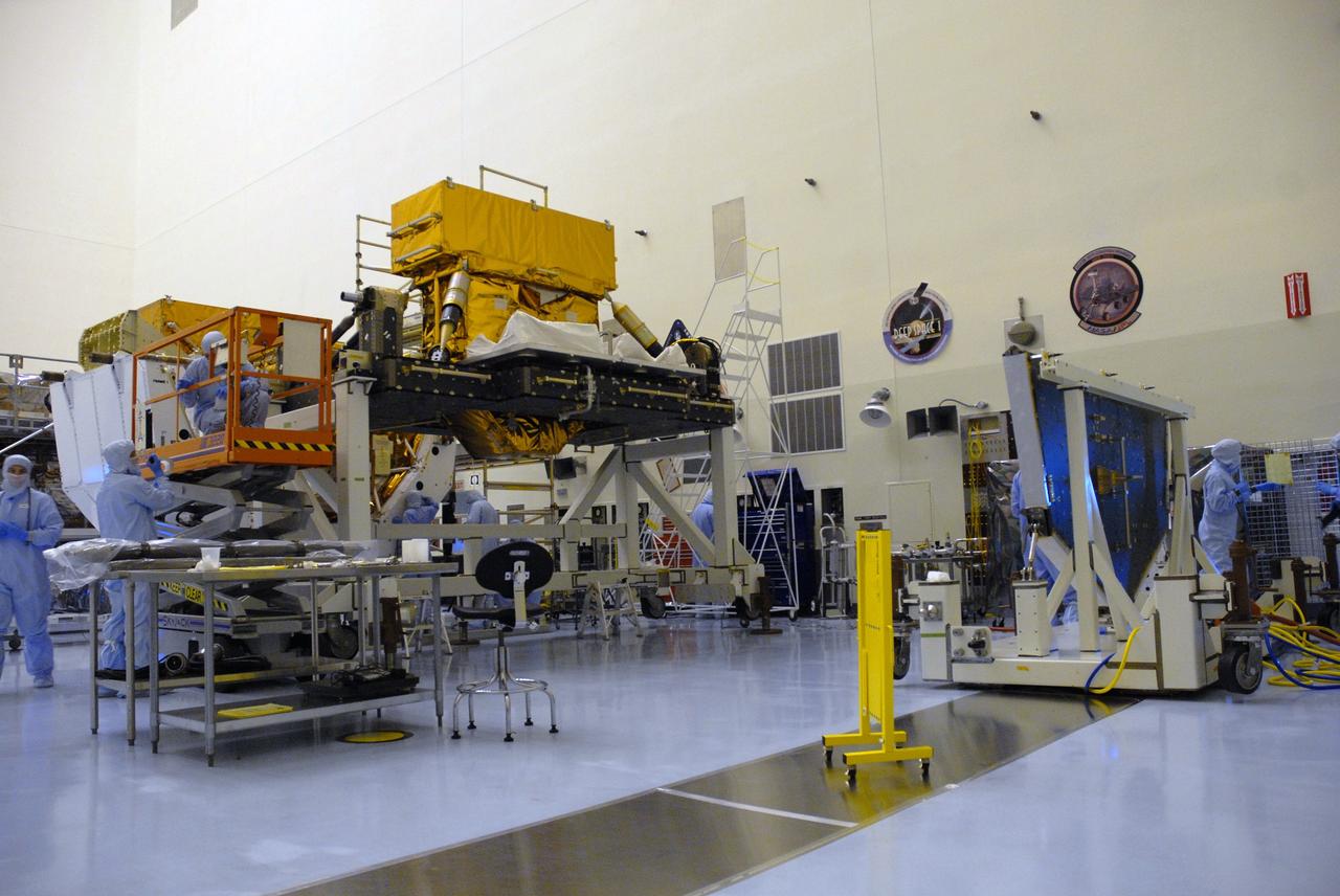 CAPE CANAVERAL, Fla. – In the high bay of the Payload Hazardous Servicing Facility at NASA's Kennedy Space Center, the Super Lightweight Interchangeable Carrier for the Hubble Space Telescope, elevated at left, is ready to be mated to the Hubble vertical platform, at right.  The Super Lightweight Interchangeable Carrier, or SLIC, is one of four carriers supporting hardware for space shuttle Atlantis' STS-125 mission to service the telescope. SLIC is built with state-of-the-art, lightweight, composite materials - carbon fiber with a cyanate ester resin and a titanium metal matrix composite. These composites have greater strength-to-mass ratios than the metals typically used in spacecraft design. The Orbital Replacement Unit Carrier, or ORUC, and the Flight Support System, or FSS, have also arrived at Kennedy.     The Multi-Use Lightweight Equipment carrier will be delivered in early August. The carriers will be prepared for the integration of telescope science instruments, both internal and external replacement components, as well as the flight support equipment to be used by the astronauts during the Hubble servicing mission, targeted for launch Oct. 8.  Photo credit: NASA/Jack Pfaller