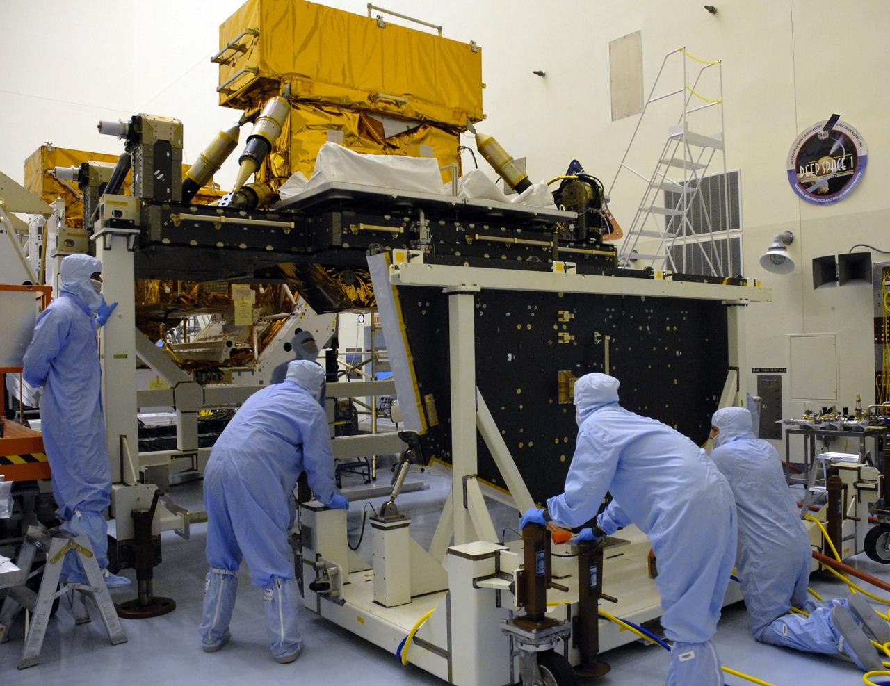 CAPE CANAVERAL, Fla. – In the high bay of the Payload Hazardous Servicing Facility at NASA's Kennedy Space Center, workers from NASA's Goddard Space Flight Center move the Hubble vertical platform toward the Super Lightweight Interchangeable Carrier for the Hubble Space Telescope, to which it will be mated.  The Super Lightweight Interchangeable Carrier, or SLIC, is one of four carriers supporting hardware for space shuttle Atlantis' STS-125 mission to service the telescope. SLIC is built with state-of-the-art, lightweight, composite materials - carbon fiber with a cyanate ester resin and a titanium metal matrix composite. These composites have greater strength-to-mass ratios than the metals typically used in spacecraft design. The Orbital Replacement Unit Carrier, or ORUC, and the Flight Support System, or FSS, have also arrived at Kennedy.    The Multi-Use Lightweight Equipment carrier will be delivered in early August. The carriers will be prepared for the integration of telescope science instruments, both internal and external replacement components, as well as the flight support equipment to be used by the astronauts during the Hubble servicing mission, targeted for launch Oct. 8.  Photo credit: NASA/Jack Pfaller