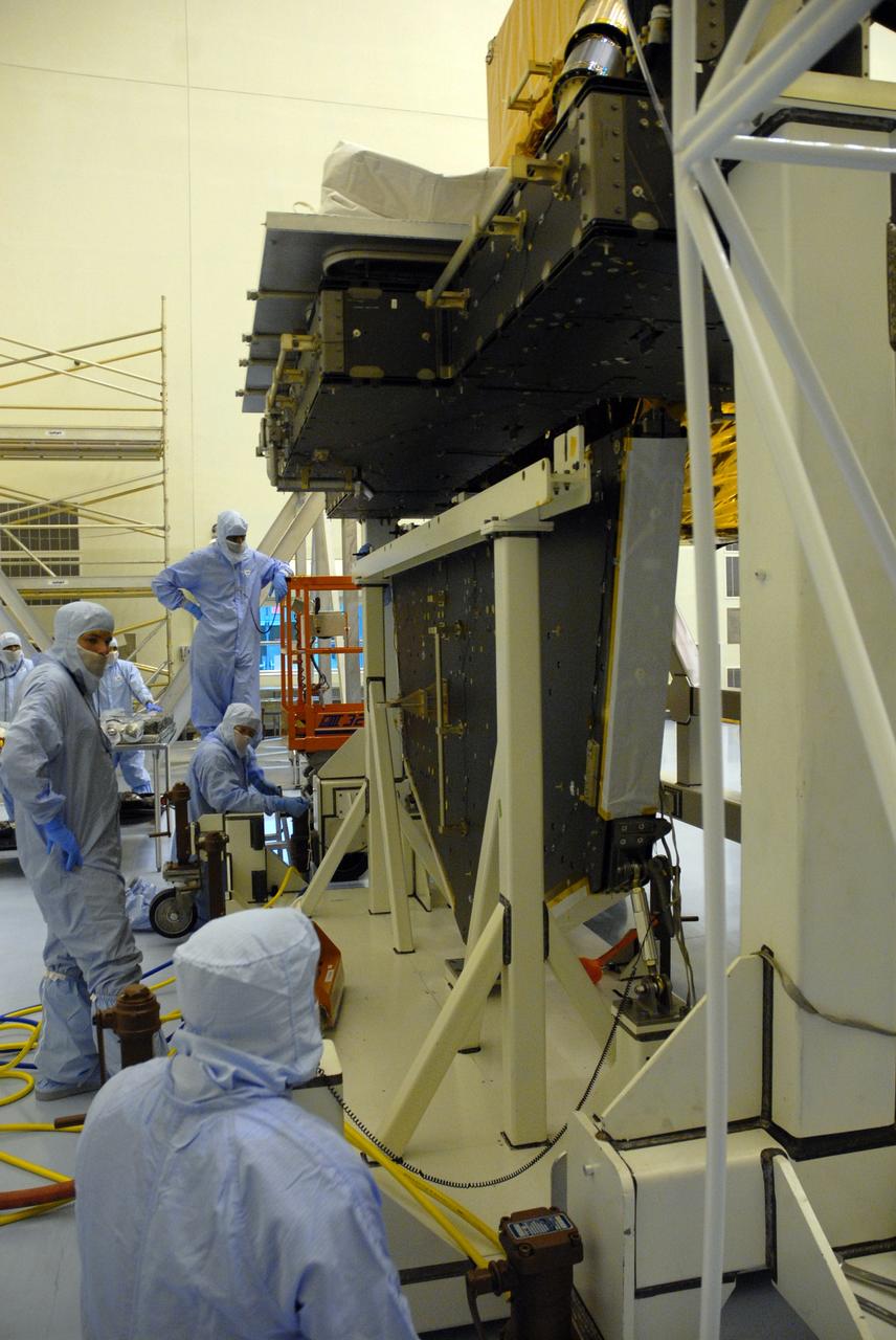 CAPE CANAVERAL, Fla. – CAPE CANAVERAL, Fla. – In the high bay of the Payload Hazardous Servicing Facility at NASA's Kennedy Space Center, workers from NASA's Goddard Space Flight Center mate the Hubble vertical platform to the Super Lightweight Interchangeable Carrier for the Hubble Space Telescope.  The Super Lightweight Interchangeable Carrier, or SLIC, is one of four carriers supporting hardware for space shuttle Atlantis' STS-125 mission to service the telescope. SLIC is built with state-of-the-art, lightweight, composite materials - carbon fiber with a cyanate ester resin and a titanium metal matrix composite. These composites have greater strength-to-mass ratios than the metals typically used in spacecraft design. The Orbital Replacement Unit Carrier, or ORUC, and the Flight Support System, or FSS, have also arrived at Kennedy.    The Multi-Use Lightweight Equipment carrier will be delivered in early August. The carriers will be prepared for the integration of telescope science instruments, both internal and external replacement components, as well as the flight support equipment to be used by the astronauts during the Hubble servicing mission, targeted for launch Oct. 8.  Photo credit: NASA/Jack Pfaller