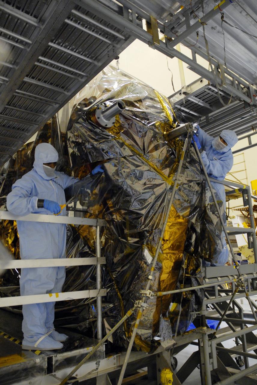 CAPE CANAVERAL, Fla. – In the high bay of the Payload Hazardous Servicing Facility at NASA's Kennedy Space Center, workers from NASA's Goddard Space Flight Center remove the protective wrapping from the Flight Support System for the Hubble Space Telescope. The Flight Support System, or FSS, is one of four carriers supporting hardware for space shuttle Atlantis' STS-125 mission to service the telescope. The Super Lightweight Interchangeable Carrier, or SLIC, and the Orbital Replacement Unit Carrier, or ORUC, have also arrived at Kennedy. The Multi-Use Lightweight Equipment carrier will be delivered in early August. The carriers will be prepared for the integration of telescope science instruments, both internal and external replacement components, as well as the flight support equipment to be used by the astronauts during the Hubble servicing mission, targeted for launch Oct. 8. Photo credit: NASA/Jack Pfaller