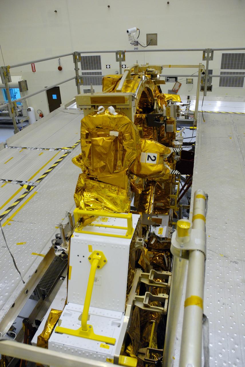 CAPE CANAVERAL, Fla. – In the high bay of the Payload Hazardous Servicing Facility at NASA's Kennedy Space Center, the protective wrapping has been removed from the Flight Support System for the Hubble Space Telescope revealing the soft capture mechanism , or SCM. The SCM will be permanently attached to Hubble’s aft shroud by spacewalking astronauts and will provide a rendezvous and docking target that can be easily seen and recognized by a docking vehicle. The Flight Support System, or FSS, is one of four carriers supporting hardware for space shuttle Atlantis' STS-125 mission to service the telescope. The Super Lightweight Interchangeable Carrier, or SLIC, and the Orbital Replacement Unit Carrier, or ORUC, have also arrived at Kennedy. The Multi-Use Lightweight Equipment carrier will be delivered in early August. The carriers will be prepared for the integration of telescope science instruments, both internal and external replacement components, as well as the flight support equipment to be used by the astronauts during the Hubble servicing mission, targeted for launch Oct. 8. Photo credit: NASA/Jack Pfaller