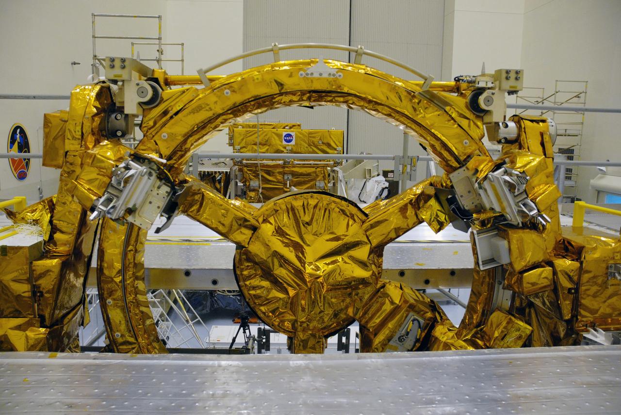 CAPE CANAVERAL, Fla. – In the high bay of the Payload Hazardous Servicing Facility at NASA's Kennedy Space Center, three of four carriers supporting the space shuttle Atlantis STS-125 Hubble Space Telescope servicing mission have been unwrapped for final launch processing.  The Super Lightweight Interchangeable Carrier and the Orbital Replacement Unit Carrier can be seen through the distinctive soft capture mechanism, or SCM, of the Flight Support System.  The SCM will be permanently attached to Hubble’s aft shroud by spacewalking astronauts and will provide a rendezvous and docking target that can be easily seen and recognized by a docking vehicle.    The Multi-Use Lightweight Equipment carrier will be delivered in early August. The carriers will be prepared for the integration of telescope science instruments, both internal and external replacement components, as well as the flight support equipment to be used by the astronauts during the Hubble servicing mission, targeted for launch Oct. 8.  Photo credit: NASA/Jack Pfaller