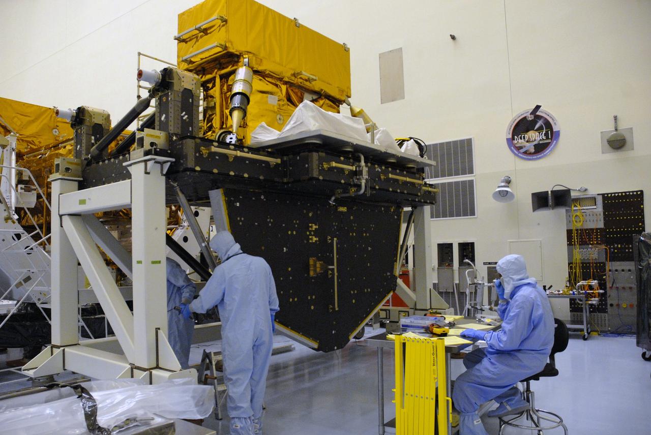CAPE CANAVERAL, Fla. -- In the high bay of the Payload Hazardous Servicing Facility at NASA's Kennedy Space Center, workers from NASA's Goddard Space Flight Center install the pallet support struts on the Super Lightweight Interchangeable Carrier for the Hubble Space Telescope.  The Super Lightweight Interchangeable Carrier, or SLIC, is one of four carriers supporting hardware for space shuttle Atlantis' STS-125 mission to service the telescope. SLIC is built with state-of-the-art, lightweight, composite materials - carbon fiber with a cyanate ester resin and a titanium metal matrix composite. These composites have greater strength-to-mass ratios than the metals typically used in spacecraft design. The Orbital Replacement Unit Carrier, or ORUC, and the Flight Support System, or FSS, have also arrived at Kennedy.     The Multi-Use Lightweight Equipment carrier will be delivered in early August. The carriers will be prepared for the integration of telescope science instruments, both internal and external replacement components, as well as the flight support equipment to be used by the astronauts during the Hubble servicing mission, targeted for launch Oct. 8.  Photo credit: NASA/Jack Pfaller