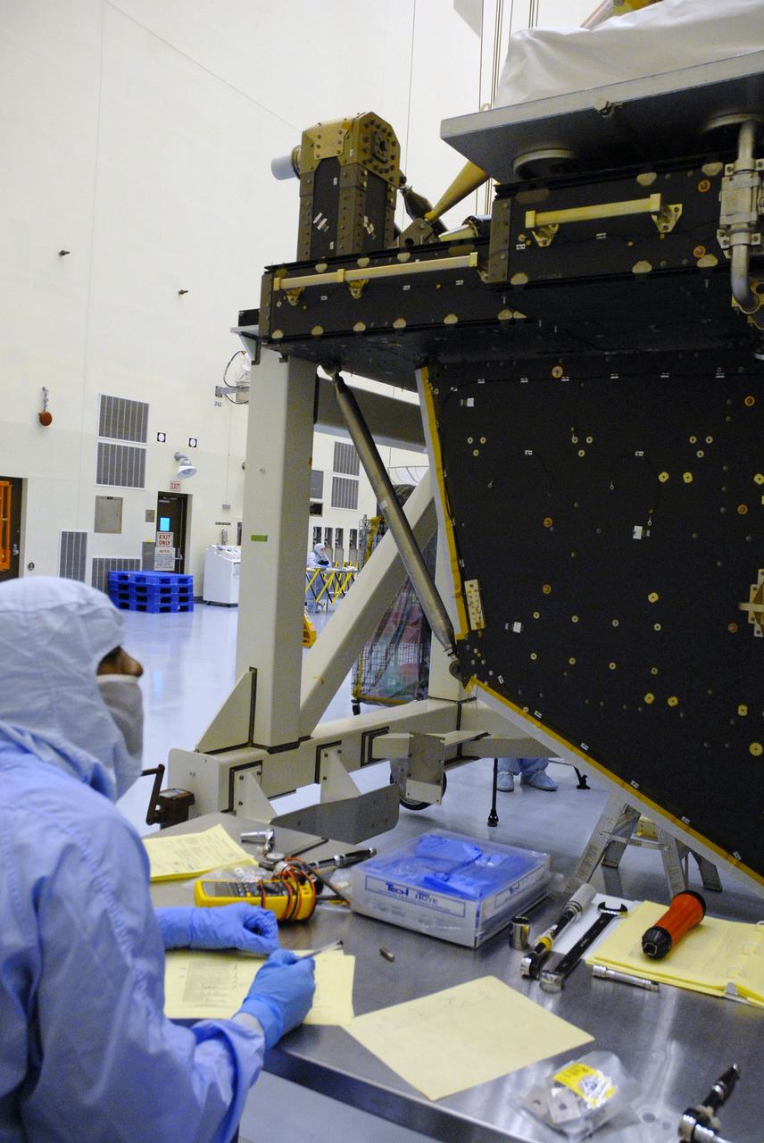 CAPE CANAVERAL, Fla. -- In the high bay of the Payload Hazardous Servicing Facility at NASA's Kennedy Space Center, a worker from NASA's Goddard Space Flight Center documents the installation of a pallet support strut on the Super Lightweight Interchangeable Carrier for the Hubble Space Telescope. The Super Lightweight Interchangeable Carrier, or SLIC, is one of four carriers supporting hardware for space shuttle Atlantis' STS-125 mission to service the telescope. SLIC is built with state-of-the-art, lightweight, composite materials - carbon fiber with a cyanate ester resin and a titanium metal matrix composite. These composites have greater strength-to-mass ratios than the metals typically used in spacecraft design. The Orbital Replacement Unit Carrier, or ORUC, and the Flight Support System, or FSS, have also arrived at Kennedy. The Multi-Use Lightweight Equipment carrier will be delivered in early August. The carriers will be prepared for the integration of telescope science instruments, both internal and external replacement components, as well as the flight support equipment to be used by the astronauts during the Hubble servicing mission, targeted for launch Oct. 8. Photo credit: NASA/Jack Pfaller