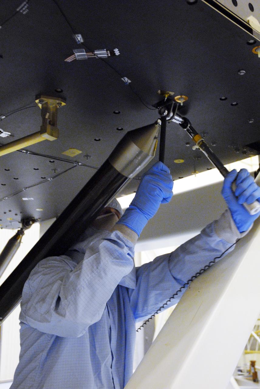 CAPE CANAVERAL, Fla. -- In the high bay of the Payload Hazardous Servicing Facility at NASA's Kennedy Space Center, a worker from NASA's Goddard Space Flight Center installs a pallet support strut on the Super Lightweight Interchangeable Carrier for the Hubble Space Telescope.  The Super Lightweight Interchangeable Carrier, or SLIC, is one of four carriers supporting hardware for space shuttle Atlantis' STS-125 mission to service the telescope. SLIC is built with state-of-the-art, lightweight, composite materials - carbon fiber with a cyanate ester resin and a titanium metal matrix composite. These composites have greater strength-to-mass ratios than the metals typically used in spacecraft design. The Orbital Replacement Unit Carrier, or ORUC, and the Flight Support System, or FSS, have also arrived at Kennedy.     The Multi-Use Lightweight Equipment carrier will be delivered in early August. The carriers will be prepared for the integration of telescope science instruments, both internal and external replacement components, as well as the flight support equipment to be used by the astronauts during the Hubble servicing mission, targeted for launch Oct. 8.  Photo credit: NASA/Jack Pfaller