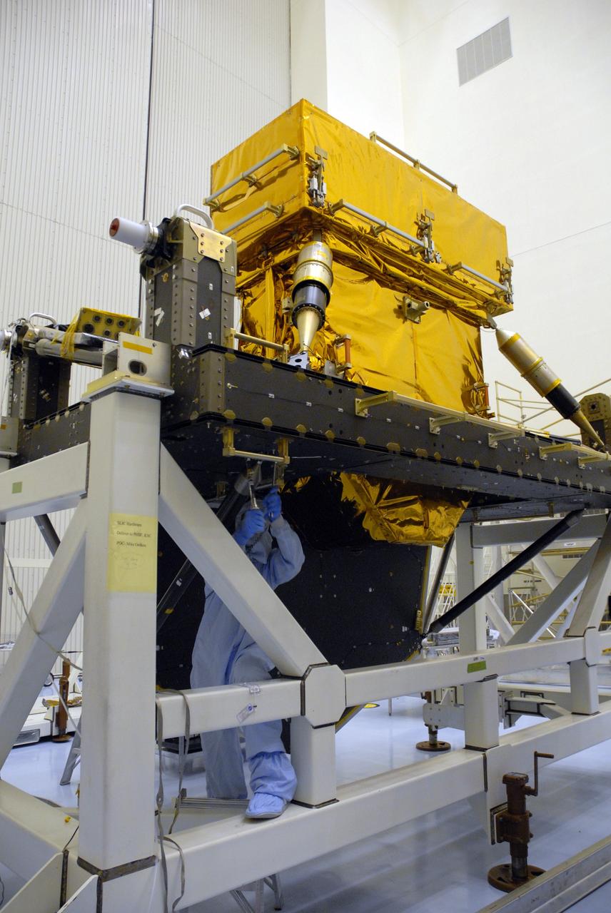 CAPE CANAVERAL, Fla. -- In the high bay of the Payload Hazardous Servicing Facility at NASA's Kennedy Space Center, a worker from NASA's Goddard Space Flight Center installs a pallet support strut on the Super Lightweight Interchangeable Carrier for the Hubble Space Telescope.  The Super Lightweight Interchangeable Carrier, or SLIC, is one of four carriers supporting hardware for space shuttle Atlantis' STS-125 mission to service the telescope. SLIC is built with state-of-the-art, lightweight, composite materials - carbon fiber with a cyanate ester resin and a titanium metal matrix composite. These composites have greater strength-to-mass ratios than the metals typically used in spacecraft design. The Orbital Replacement Unit Carrier, or ORUC, and the Flight Support System, or FSS, have also arrived at Kennedy.    The Multi-Use Lightweight Equipment carrier will be delivered in early August. The carriers will be prepared for the integration of telescope science instruments, both internal and external replacement components, as well as the flight support equipment to be used by the astronauts during the Hubble servicing mission, targeted for launch Oct. 8.  Photo credit: NASA/Jack Pfaller