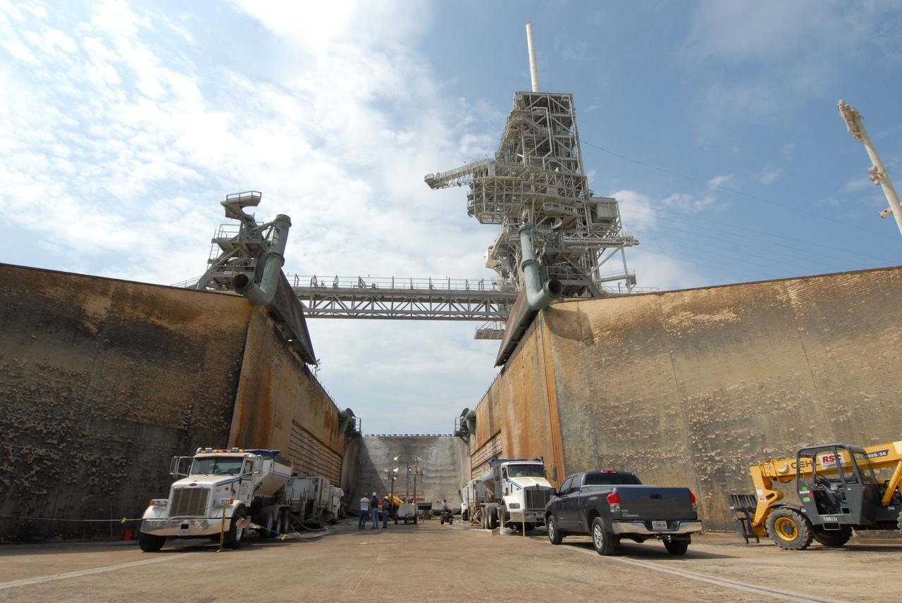 CAPE CANAVERAL, Fla. – Workers prepare to weld a steel grid structure to the wall of the flame trench on Launch Pad 39A at NASA's Kennedy Space Center. Damage to the trench occurred during the launch of Discovery on the STS-124 mission. A 75- by 20-foot section of the east wall was destroyed and debris scattered as far as the pad perimeter fence. Repairs are expected to be completed before the targeted Oct. 8 launch of Atlantis on the NASA Hubble Space Telescope servicing mission. Photo credit: NASA/Jack Pfaller