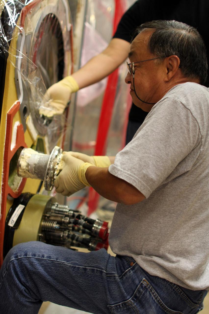 CAPE CANAVERAL, Fla. – Inside the Vehicle Assembly Building at NASA’s Kennedy Space Center, a technician removes a valve from Atlantis’ external tank after small dings were found on the sealing surface of the quick disconnect system that handles liquid-hydrogen fuel for the shuttle’s three main engines. The tank will be attached to the twin solid rocket boosters on Aug. 3 for the STS-125 mission, the fifth and final shuttle servicing mission to NASA’s Hubble Space Telescope. During the mission, the crew will install new instruments on the telescope, including the Cosmic Origins Spectrograph and the Wide Field Camera 3. A refurbished Fine Guidance Sensor will replace one unit of three now onboard. Mission specialists will also install new gyroscopes, batteries and thermal blankets on the telescope. Launch is targeted for Oct. 8. Photo credit: NASA/Dimitri Gerondidakis