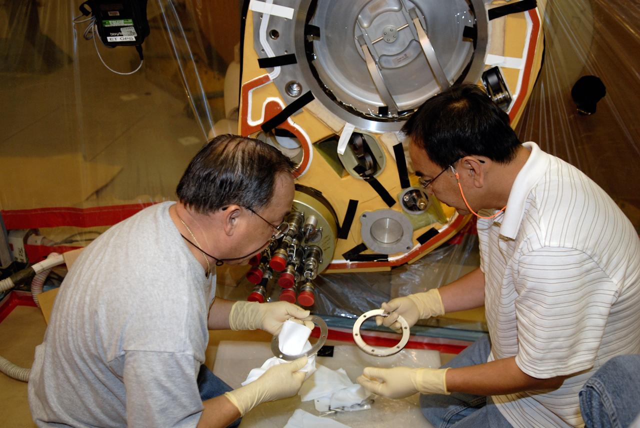 CAPE CANAVERAL, Fla. – Inside the Vehicle Assembly Building at NASA's Kennedy Space Center, technicians replace a valve on Atlantis’ external tank after small dings were found on the sealing surface of the quick disconnect system that handles liquid-hydrogen fuel for the shuttle’s three main engines. The tank will be attached to the twin solid rocket boosters on Aug. 3 for the STS-125 mission, the fifth and final shuttle servicing mission to NASA’s Hubble Space Telescope. During the mission, the crew will install new instruments on the telescope, including the Cosmic Origins Spectrograph and the Wide Field Camera 3. A refurbished Fine Guidance Sensor will replace one unit of three now onboard. Mission specialists will also install new gyroscopes, batteries and thermal blankets on the telescope. Launch is targeted for Oct. 8. Photo credit: NASA/Kim Shiflett