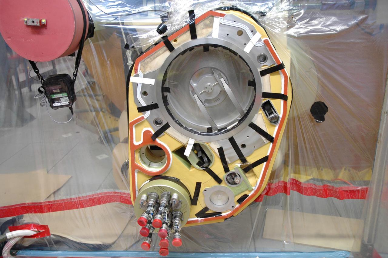 CAPE CANAVERAL, Fla. – Inside a test cell in the Vehicle Assembly Building at NASA's Kennedy Space Center, a portion of Atlantis’ external tank is sealed to prevent contamination so that technicians can replace a valve after small dings were found on the sealing surface of the quick disconnect system that handles liquid-hydrogen fuel for the shuttle’s three main engines. The tank will be attached to the twin solid rocket boosters on Aug. 3 for the STS-125 mission, the fifth and final shuttle servicing mission to NASA’s Hubble Space Telescope. During the mission, the crew will install new instruments on the telescope, including the Cosmic Origins Spectrograph and the Wide Field Camera 3. A refurbished Fine Guidance Sensor will replace one unit of three now onboard. Mission specialists will also install new gyroscopes, batteries and thermal blankets on the telescope. Launch is targeted for Oct. 8. Photo credit: NASA/Jim Grossmann