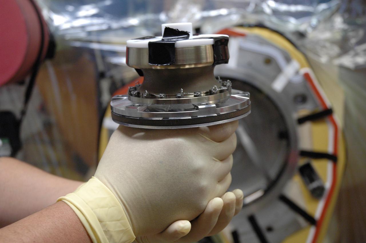 CAPE CANAVERAL, Fla. – Inside the Vehicle Assembly Building at NASA's Kennedy Space Center, a technician holds the replacement valve for Atlantis’ external tank. Technicians removed an old valve after small dings were found on the sealing surface of the quick disconnect system that handles liquid-hydrogen fuel for the shuttle’s three main engines. The tank will be attached to the twin solid rocket boosters on Aug. 3 for the STS-125 mission, the fifth and final shuttle servicing mission to NASA’s Hubble Space Telescope. During the mission, the crew will install new instruments on the telescope, including the Cosmic Origins Spectrograph and the Wide Field Camera 3. A refurbished Fine Guidance Sensor will replace one unit of three now onboard. Mission specialists will also install new gyroscopes, batteries and thermal blankets on the telescope. Launch is targeted for Oct. 8. Photo credit: NASA/Jim Grossmann