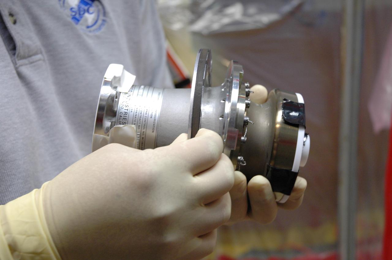 CAPE CANAVERAL, Fla. – Inside the Vehicle Assembly Building at NASA's Kennedy Space Center, a technician holds the replacement valve for Atlantis’ external tank. Technicians removed an old valve after small dings were found on the sealing surface of the quick disconnect system that handles liquid-hydrogen fuel for the shuttle’s three main engines. The tank will be attached to the twin solid rocket boosters on Aug. 3 for the STS-125 mission, the fifth and final shuttle servicing mission to NASA’s Hubble Space Telescope. During the mission, the crew will install new instruments on the telescope, including the Cosmic Origins Spectrograph and the Wide Field Camera 3. A refurbished Fine Guidance Sensor will replace one unit of three now onboard. Mission specialists will also install new gyroscopes, batteries and thermal blankets on the telescope. Launch is targeted for Oct. 8. Photo credit: NASA/Jim Grossmann