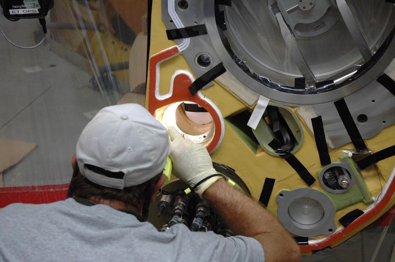 CAPE CANAVERAL, Fla. – Inside the Vehicle Assembly Building at NASA's Kennedy Space Center, a technician prepares to install a new valve on Atlantis’ external tank after small dings were found on the sealing surface of the quick disconnect system that handles liquid-hydrogen fuel for the shuttle’s three main engines. The tank will be attached to the twin solid rocket boosters on Aug. 3 for the STS-125 mission, the fifth and final shuttle servicing mission to NASA’s Hubble Space Telescope. During the mission, the crew will install new instruments on the telescope, including the Cosmic Origins Spectrograph and the Wide Field Camera 3. A refurbished Fine Guidance Sensor will replace one unit of three now onboard. Mission specialists will also install new gyroscopes, batteries and thermal blankets on the telescope. Launch is targeted for Oct. 8. Photo credit: NASA/Jim Grossmann