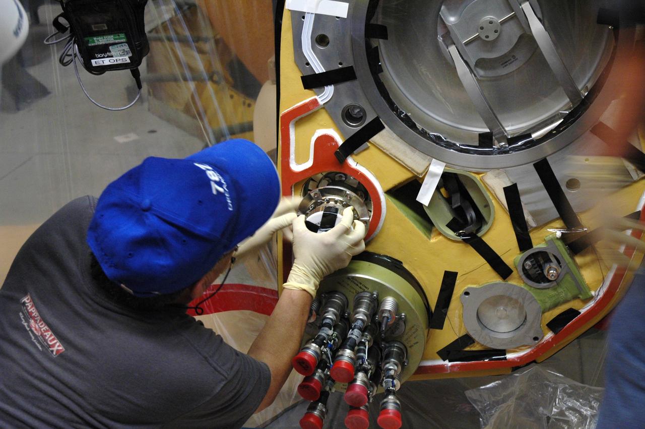 CAPE CANAVERAL, Fla. – Inside the Vehicle Assembly Building at NASA’s Kennedy Space Center, a technician installs a new valve on Atlantis’ external tank after small dings were found on the sealing surface of the quick disconnect system that handles liquid-hydrogen fuel for the shuttle’s three main engines. The tank will be attached to the twin solid rocket boosters on Aug. 3 for the STS-125 mission, the fifth and final shuttle servicing mission to NASA’s Hubble Space Telescope. During the mission, the crew will install new instruments on the telescope, including the Cosmic Origins Spectrograph and the Wide Field Camera 3. A refurbished Fine Guidance Sensor will replace one unit of three now onboard. Mission specialists will also install new gyroscopes, batteries and thermal blankets on the telescope. Launch is targeted for Oct. 8. Photo credit: NASA/Jim Grossmann