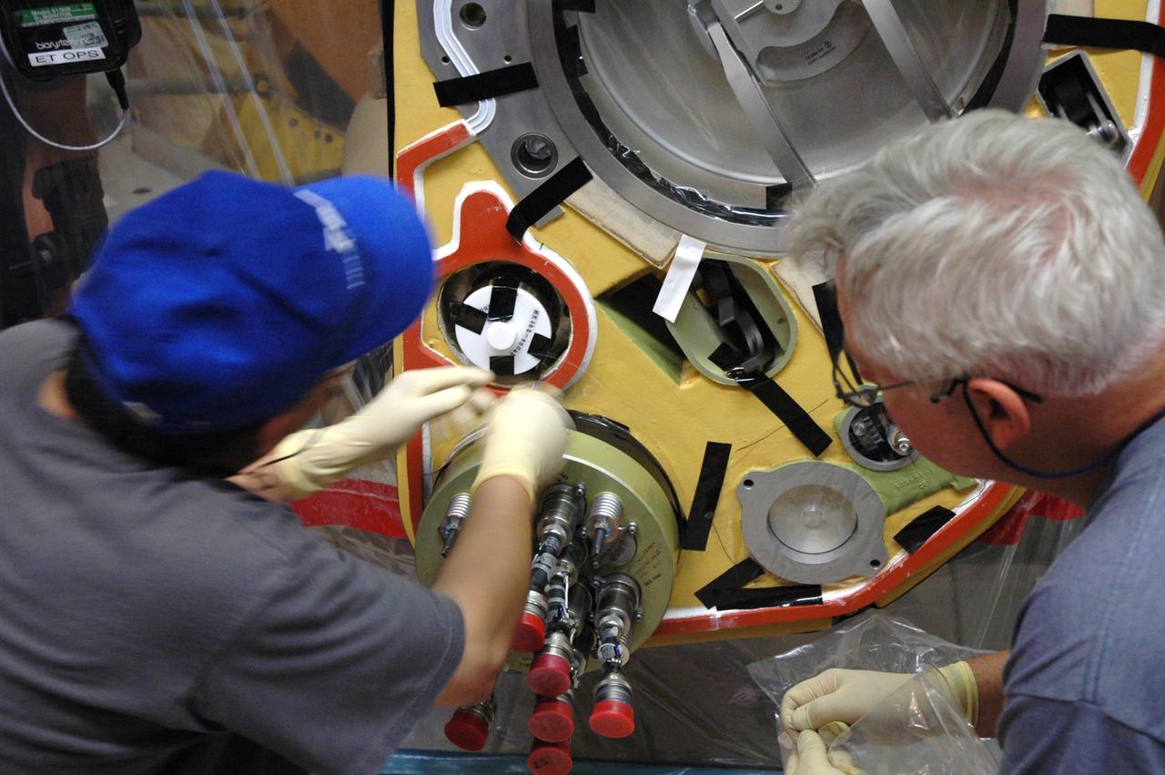 CAPE CANAVERAL, Fla. – Inside the Vehicle Assembly Building at NASA’s Kennedy Space Center, technicians install a new valve on Atlantis’ external tank after small dings were found on the sealing surface of the quick disconnect system that handles liquid-hydrogen fuel for the shuttle’s three main engines. The tank will be attached to the twin solid rocket boosters on Aug. 3 for the STS-125 mission, the fifth and final shuttle servicing mission to NASA’s Hubble Space Telescope. During the mission, the crew will install new instruments on the telescope, including the Cosmic Origins Spectrograph and the Wide Field Camera 3. A refurbished Fine Guidance Sensor will replace one unit of three now onboard. Mission specialists will also install new gyroscopes, batteries and thermal blankets on the telescope. Launch is targeted for Oct. 8. Photo credit: NASA/Jim Grossmann