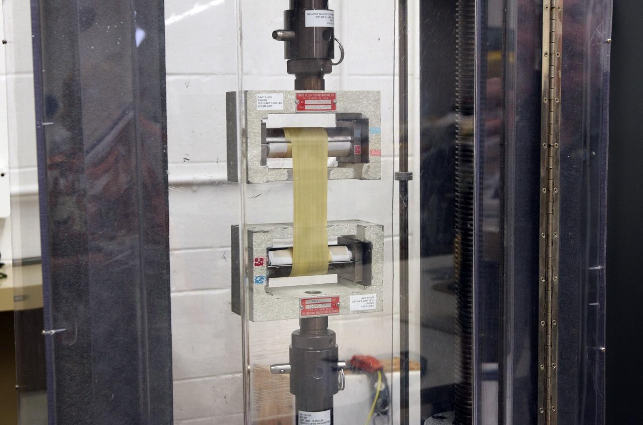 CAPE CANAVERAL, Fla. –  A look at strapping equipment used on parachutes in the Parachute Refurbishment Facility at NASA's Kennedy Space Center.  Ares I is an in-line, two-stage rocket that will transport the Orion crew exploration vehicle to low-Earth orbit. The Ares I first stage will be a five-segment solid rocket booster based on the four-segment design used for the shuttle. As with the shuttle, this booster will fall away when spent, lowered by parachute into the Atlantic Ocean where it can be retrieved for re-use. Photo credit: NASA/Dimitri Gerondidakis