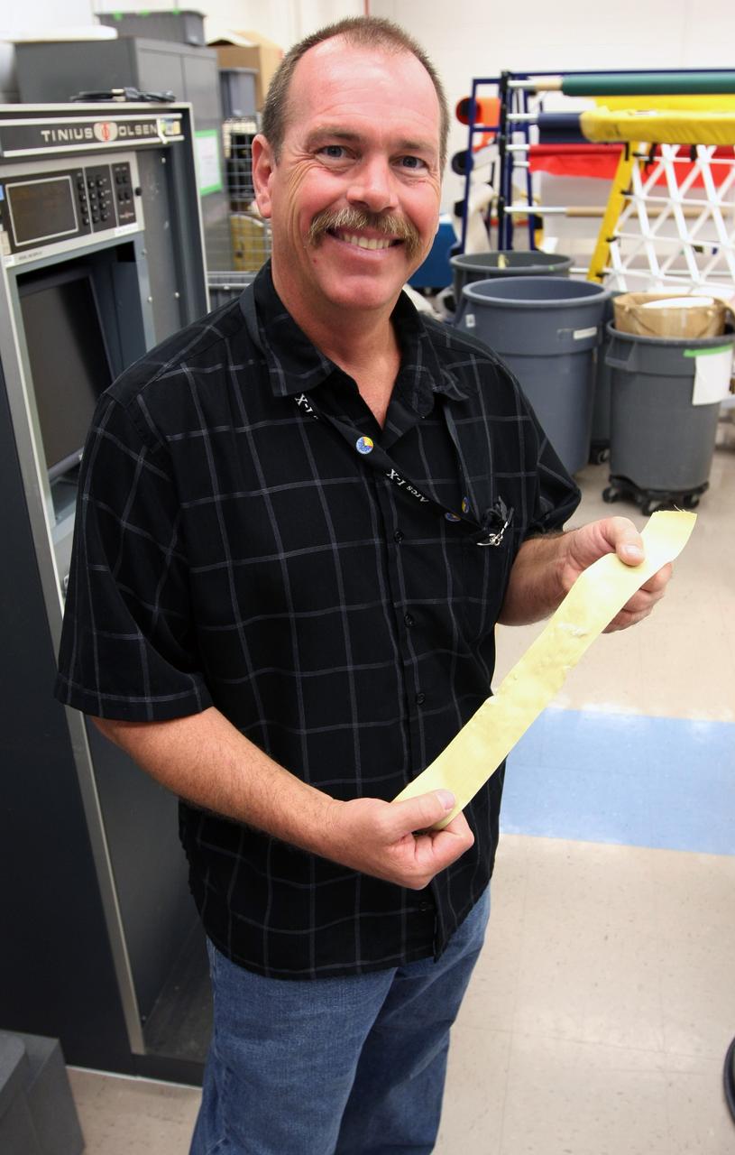 CAPE CANAVERAL, Fla. –  In the Parachute Refurbishment Facility at NASA's Kennedy Space Center, Dave Hillebrandt checks strapping used on Ares-I parachutes.   Ares I is an in-line, two-stage rocket that will transport the Orion crew exploration vehicle to low-Earth orbit. The Ares I first stage will be a five-segment solid rocket booster based on the four-segment design used for the shuttle. As with the shuttle, this booster will fall away when spent, lowered by parachute into the Atlantic Ocean where it can be retrieved for re-use. Photo credit: NASA/Dimitri Gerondidakis