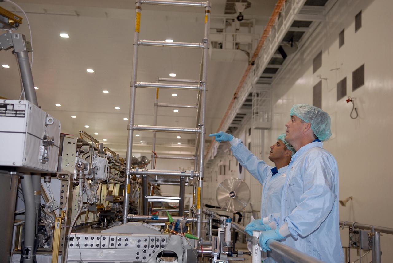 CAPE CANAVERAL, Fla. – In the Space Station Processing Facility at NASA's Kennedy Space Center, STS-119 Mission Specialists Joseph Acaba, left, and Richard Arnold inspect hardware slated to fly on their upcoming space shuttle mission. On the STS-119 mission, space shuttle Discovery will carry the S6 truss segment to complete the 361-foot-long backbone of the International Space Station. The truss includes the fourth pair of solar array wings and electronics that convert sunlight to power for the orbiting laboratory. Launch is targeted for Feb. 12, 2009. Photo credit: NASA/Kim Shiflett