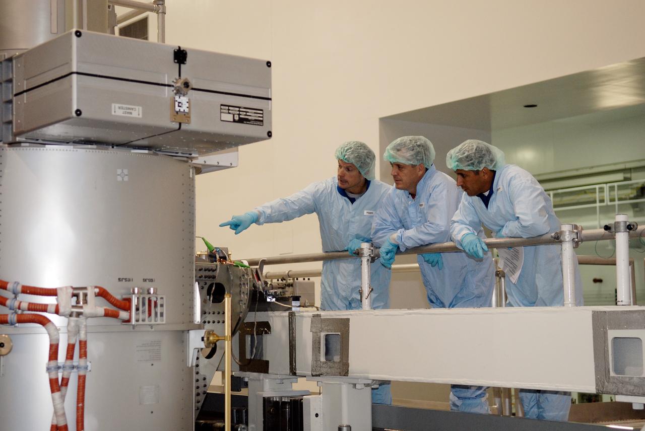 CAPE CANAVERAL, Fla. – In the Space Station Processing Facility at NASA's Kennedy Space Center, from left, STS-119 Mission Specialists Steve Swanson, Richard Arnold and Joseph Acaba inspect hardware slated to fly on their upcoming space shuttle mission.  On the STS-119 mission, space shuttle Discovery will carry the S6 truss segment to complete the 361-foot-long backbone of the International Space Station. The truss includes the fourth pair of solar array wings and electronics that convert sunlight to power for the orbiting laboratory. Launch is targeted for Feb. 12, 2009. Photo credit: NASA/Kim Shiflett