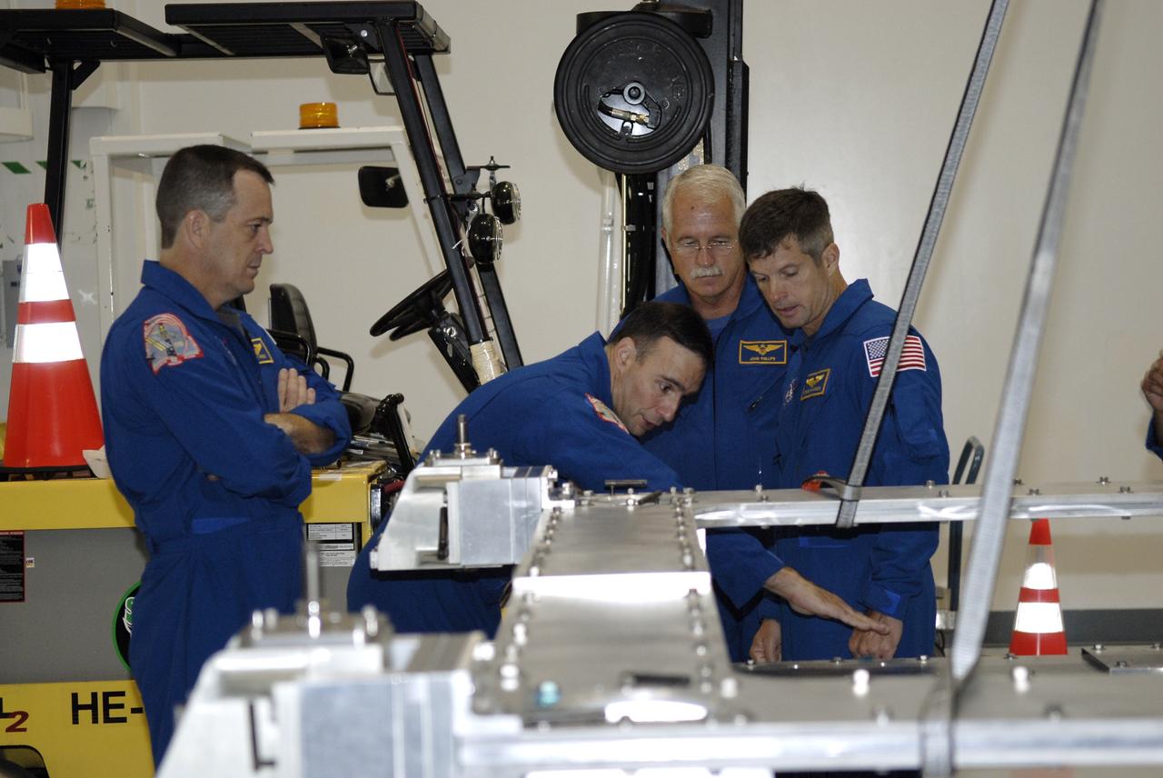 CAPE CANAVERAL, Fla. – In the Space Station Processing Facility at NASA's Kennedy Space Center, from left, STS-119 Mission Specialist Richard Arnold, Commander Lee Archambault, and Mission Specialists John Phillips and Steve Swanson familiarize themselves with hardware slated to fly on their upcoming space shuttle mission.  On the STS-119 mission, space shuttle Discovery will carry the S6 truss segment to complete the 361-foot-long backbone of the International Space Station. The truss includes the fourth pair of solar array wings and electronics that convert sunlight to power for the orbiting laboratory. Launch is targeted for Feb. 12, 2009. Photo credit: NASA/Kim Shiflett