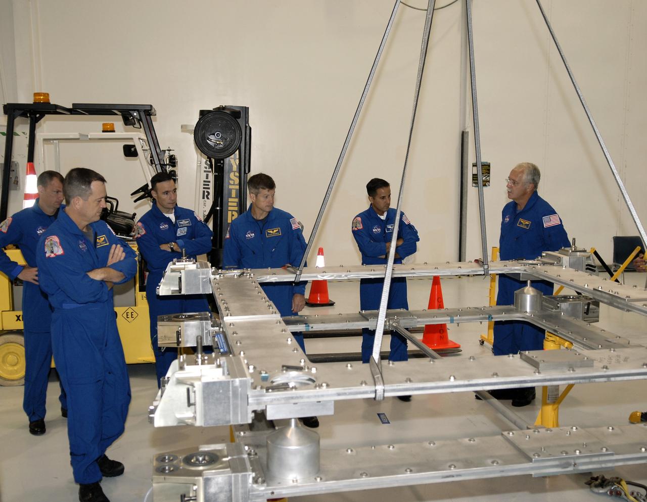 CAPE CANAVERAL, Fla. – In the Space Station Processing Facility at NASA's Kennedy Space Center, the STS-119 crew takes time to familiarize themselves with hardware slated to fly on their upcoming space shuttle mission.  From left are Pilot Tony Antonelli, Mission Specialist Richard Arnold, Commander Lee Archambault, and Mission Specialists Steve Swanson, Joseph Acaba and John Phillips.  On the STS-119 mission, space shuttle Discovery will carry the S6 truss segment to complete the 361-foot-long backbone of the International Space Station. The truss includes the fourth pair of solar array wings and electronics that convert sunlight to power for the orbiting laboratory. Launch is targeted for Feb. 12, 2009. Photo credit: NASA/Kim Shiflett