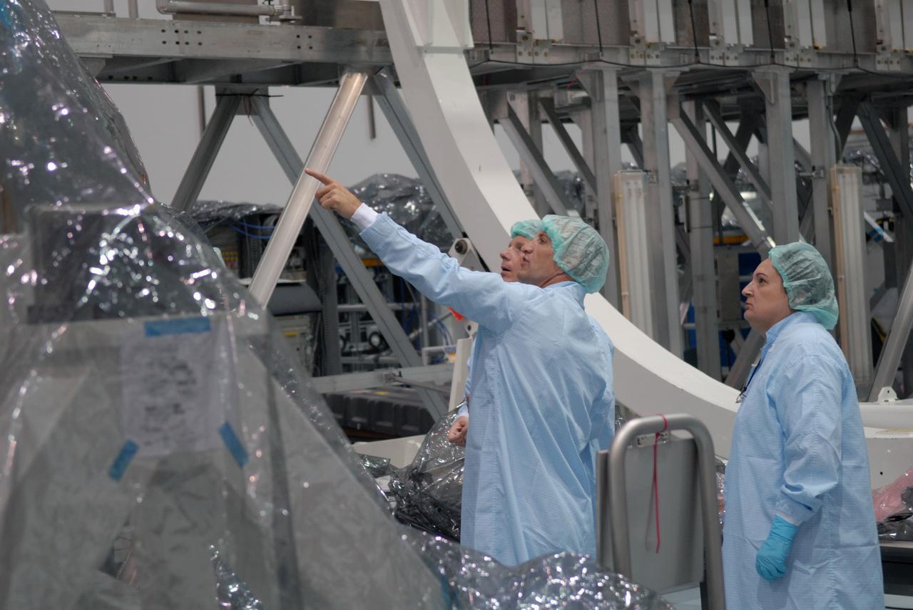 CAPE CANAVERAL, Fla. – In the Space Station Processing Facility at NASA's Kennedy Space Center, astronauts Terry Virts, left, and Charles Hobaugh, pointing, familiarize themselves with the International Space Station's Cupola module. Vehicle integration test engineer Louise Kleba of Flight Crew Operations looks on, at right. The module was delivered by the European Space Agency in 2004 to Kennedy from Alenia Spazio in Turin, Italy. Cupola will provide unprecedented views of activities outside the station and spectacular views of the Earth. Crew members working inside the module will have a 360-degree panoramic view. Cupola has the capability for command and control workstations to be installed to assist in space station remote manipulator system and extra vehicular activities. Cupola is the final element of the space station core and is scheduled for launch on space shuttle Endeavour's STS-130 mission, targeted for Dec. 10, 2009. Photo credit: NASA/Cory Huston