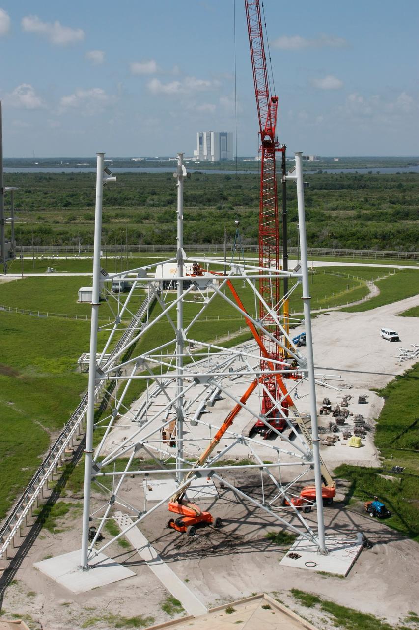CAPE CANAVERAL, Fla. –   On Launch Pad 39B at NASA's Kennedy Space Center, lightning towers are being constructed to hold centenary wires as part of the new lightning protection system for the Constellation Program and Ares/Orion launches.  Pad B will be the site of the first Ares vehicle launch, including Ares I-X which is scheduled for April 2009. Photo credit: NASA/Jim Grossmann