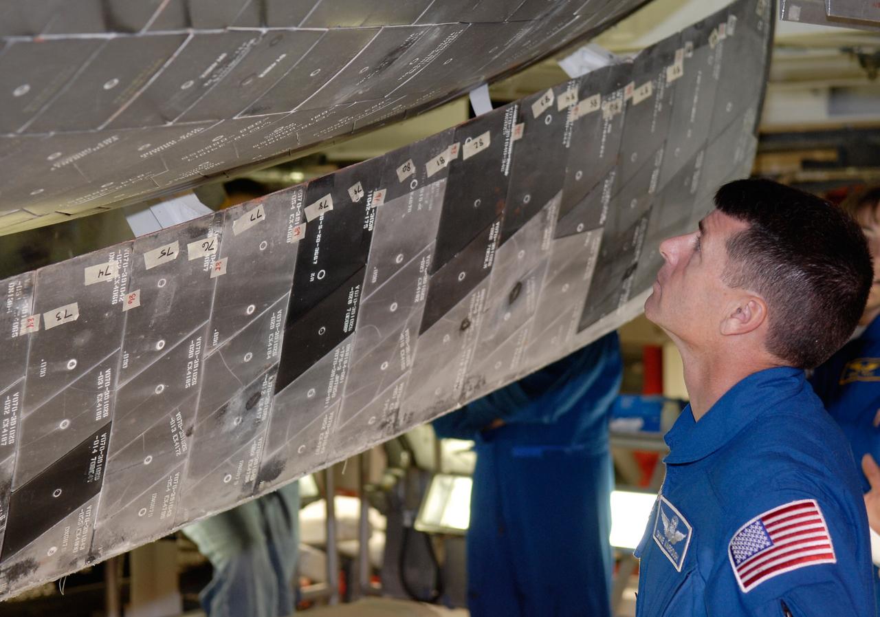 CAPE CANAVERAL, Fla. – In Orbiter Processing Facility 2 at NASA's Kennedy Space Center, members of space shuttle Endeavour's STS-126 crew participate in a crew equipment interface test, or CEIT. Here, Mission Specialist Shane Kimbrough examines the thermal protection system tile on Endeavour. The CEIT provides hands-on experience with hardware and equipment slated to fly on their mission. Endeavour will deliver a multi-purpose logistics module to the International Space Station on the STS-126 mission. Launch is targeted for Nov. 10. Photo credit: NASA/Kim Shiflett