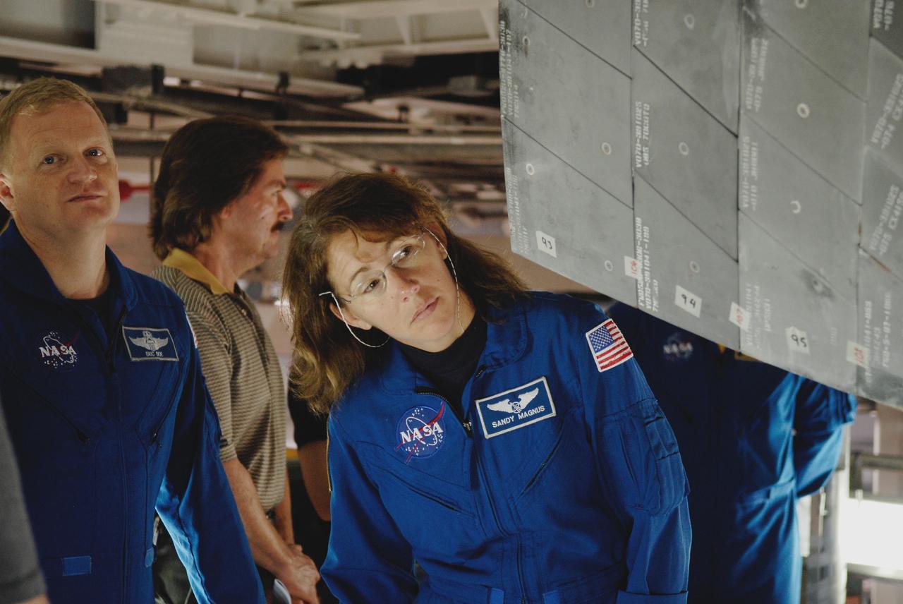 CAPE CANAVERAL, Fla. – In Orbiter Processing Facility 2 at NASA's Kennedy Space Center, members of space shuttle Endeavour's STS-126 crew participate in a crew equipment interface test, or CEIT. Here, Pilot Eric Boe, left, and International Space Station Expedition 18 flight engineer Sandra Magnus examine the thermal protection system tile on Endeavour. The CEIT provides hands-on experience with hardware and equipment slated to fly on their mission. Endeavour will deliver a multi-purpose logistics module to the International Space Station on the STS-126 mission. Launch is targeted for Nov. 10. Photo credit: NASA/Kim Shiflett