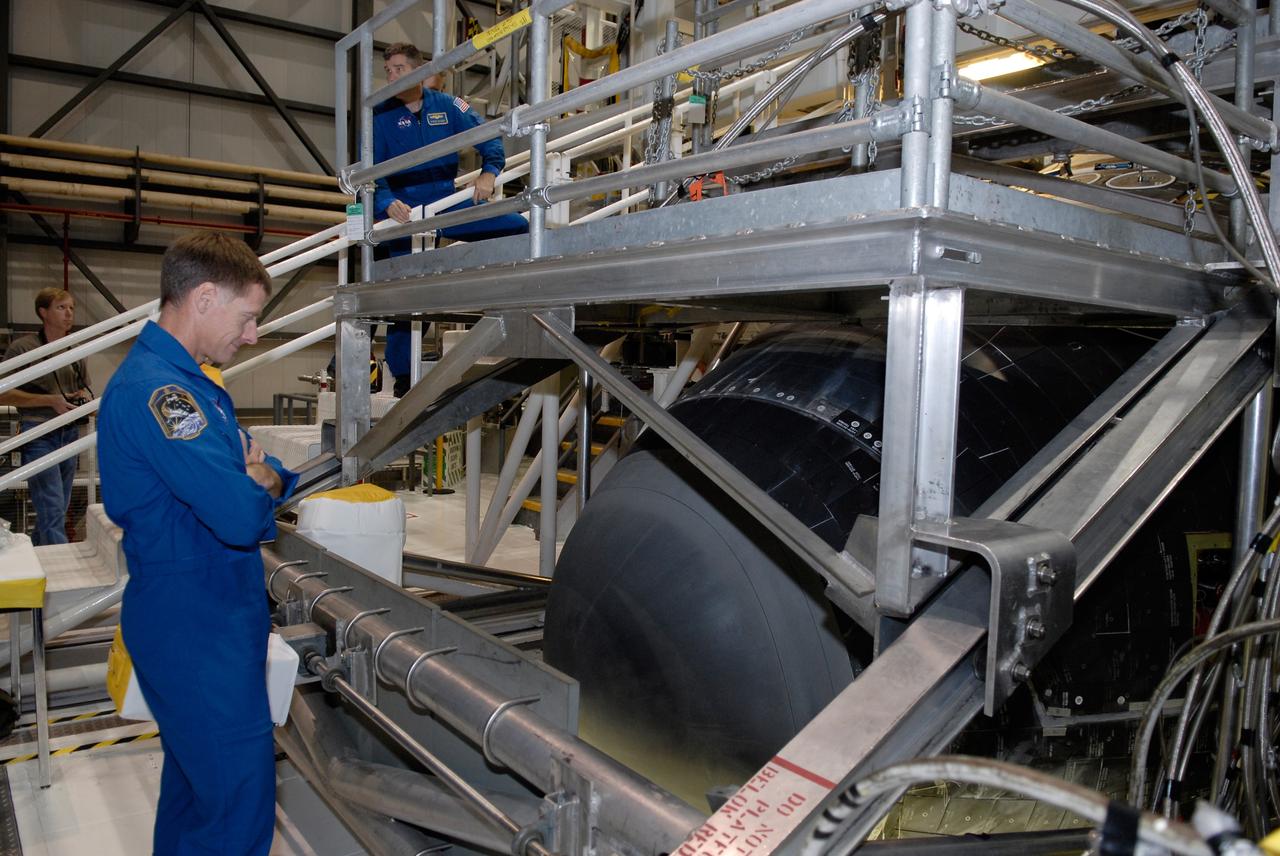 CAPE CANAVERAL, Fla. – In Orbiter Processing Facility 2 at NASA's Kennedy Space Center, members of space shuttle Endeavour's STS-126 crew participate in a crew equipment interface test, or CEIT. Here, Commander Chris Ferguson examines the nose cone of Endeavour. The CEIT provides hands-on experience with hardware and equipment slated to fly on their mission. Endeavour will deliver a multi-purpose logistics module to the International Space Station on the STS-126 mission. Launch is targeted for Nov. 10. Photo credit: NASA/Kim Shiflett