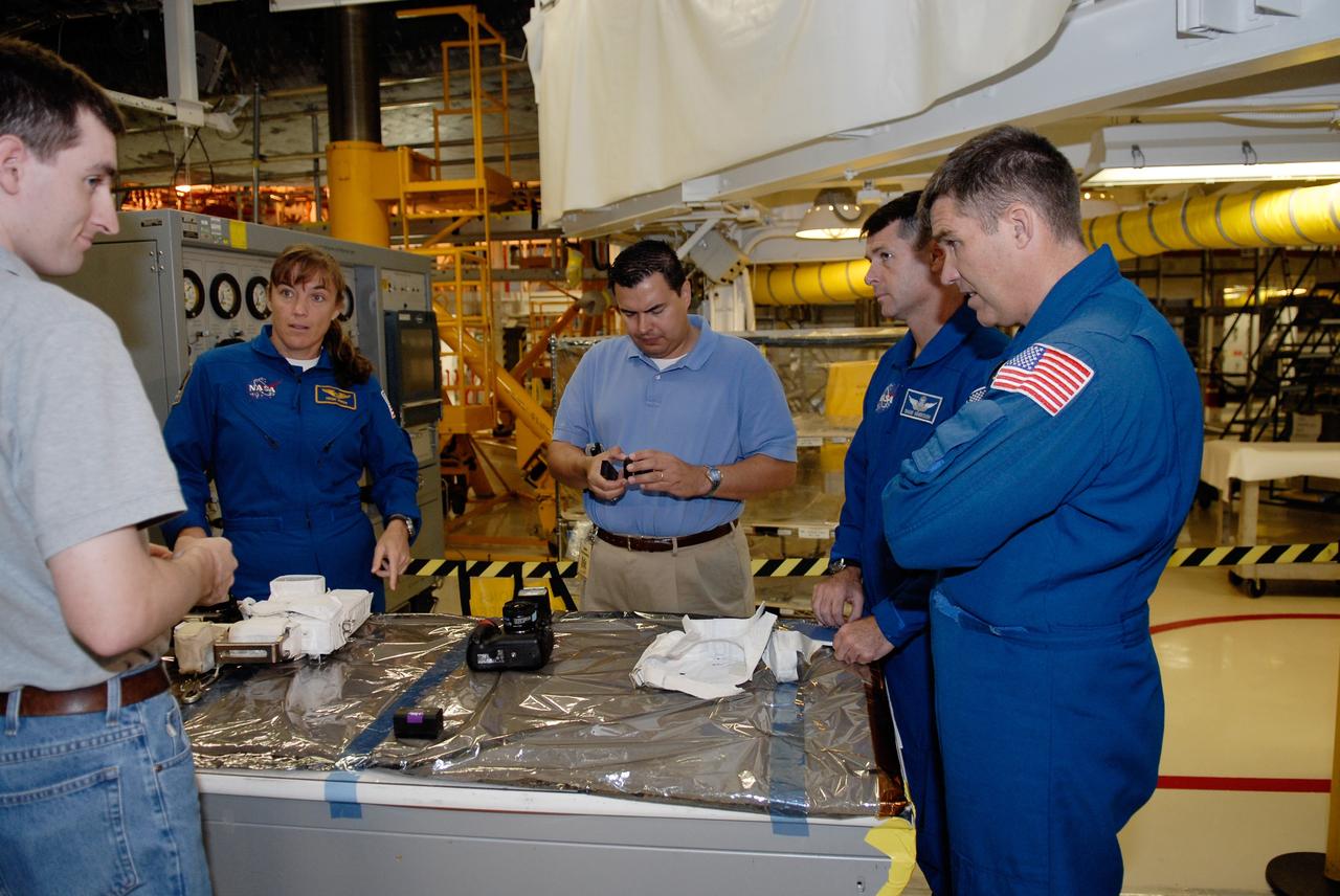 CAPE CANAVERAL, Fla. – In Orbiter Processing Facility 2 at NASA's Kennedy Space Center, members of space shuttle Endeavour's STS-126 crew participate in a crew equipment interface test, or CEIT. From left in the blue flight suits are Mission Specialists Heidemarie Stefanyshyn-Piper, Shane Kimbrough and Steve Bowen. The CEIT provides hands-on experience with hardware and equipment slated to fly on their mission. Endeavour will deliver a multi-purpose logistics module to the International Space Station on the STS-126 mission. Launch is targeted for Nov. 10. Photo credit: NASA/Kim Shiflett