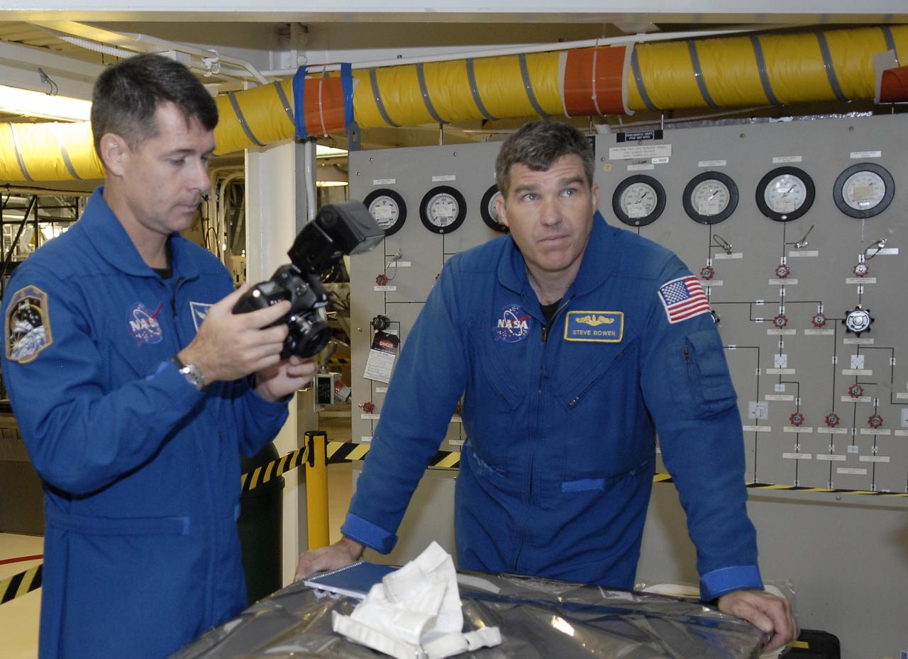 CAPE CANAVERAL, Fla. – In Orbiter Processing Facility 2 at NASA's Kennedy Space Center, members of space shuttle Endeavour's STS-126 crew participate in a crew equipment interface test, or CEIT. From left are Mission Specialists Shane Kimbrough and Steve Bowen. The CEIT provides hands-on experience with hardware and equipment slated to fly on their mission. Endeavour will deliver a multi-purpose logistics module to the International Space Station on the STS-126 mission. Launch is targeted for Nov. 10. Photo credit: NASA/Kim Shiflett