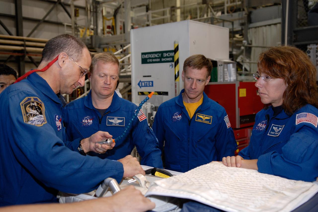 CAPE CANAVERAL, Fla. – In Orbiter Processing Facility 2 at NASA's Kennedy Space Center, members of space shuttle Endeavour's STS-126 crew participate in a crew equipment interface test, or CEIT. From left in the blue flight suits are Mission Specialists Donald Pettit, Pilot Eric Boe, Commander Chris Ferguson and International Space Station Expedition 18 flight engineer Sandra Magnus. The CEIT provides hands-on experience with hardware and equipment slated to fly on their mission. Endeavour will deliver a multi-purpose logistics module to the International Space Station on the STS-126 mission. Launch is targeted for Nov. 10. Photo credit: NASA/Kim Shiflett