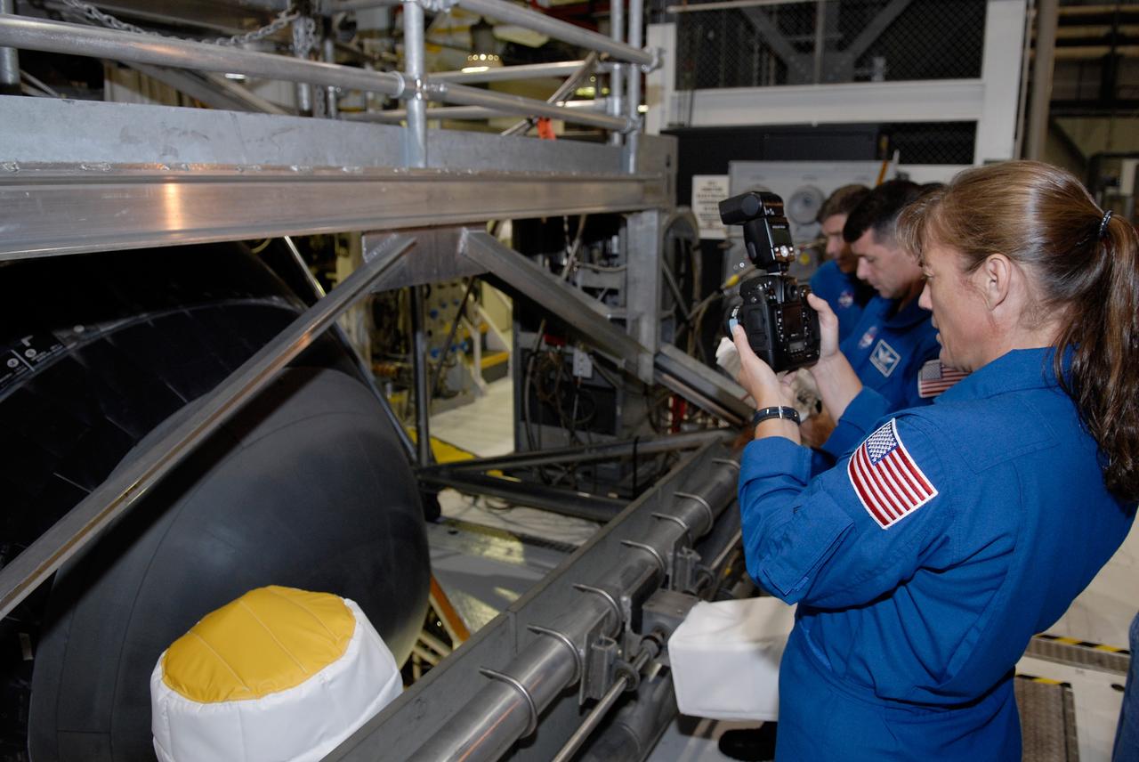 CAPE CANAVERAL, Fla. – In Orbiter Processing Facility 2 at NASA's Kennedy Space Center, members of space shuttle Endeavour's STS-126 crew participate in a crew equipment interface test, or CEIT. Here, Mission Specialist Heidemarie Stefanyshyn-Piper practices using one of the cameras that will fly on the mission. The CEIT provides hands-on experience with hardware and equipment slated to fly on their mission. Endeavour will deliver a multi-purpose logistics module to the International Space Station on the STS-126 mission. Launch is targeted for Nov. 10. Photo credit: NASA/Kim Shiflett