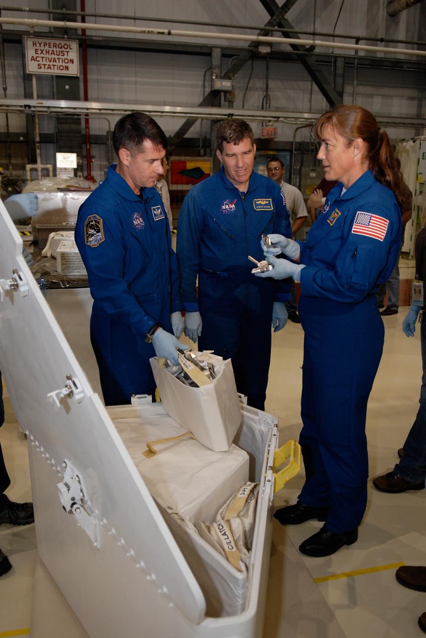 CAPE CANAVERAL, Fla. –  In Orbiter Processing Facility 2 at NASA's Kennedy Space Center, STS-126 Mission Specialists (from left) Steve Bowen, Shane Kimbrough and Heidemarie Stefanyshyn-Piper handle tools required for the mission. Members of space shuttle Endeavour's STS-126 crew are at Kennedy to participate in a crew equipment interface test, or CEIT.  The CEIT provides experience handling tools, equipment and hardware they will use on the mission. Endeavour will deliver a multi-purpose logistics module to the International Space Station on the STS-126 mission. Launch is targeted for Nov. 10.  Photo credit: NASA/Kim Shiflett
